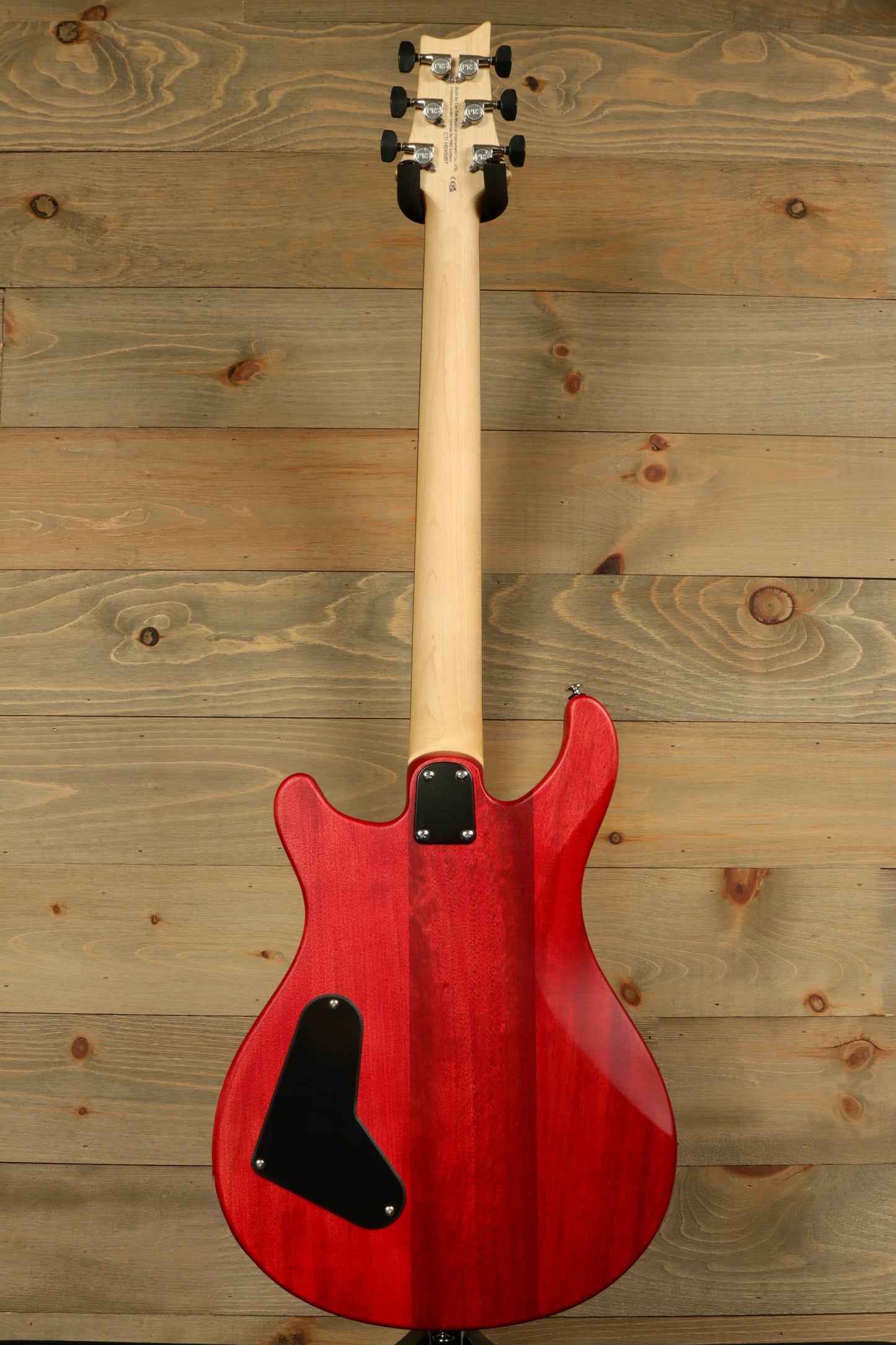 Back view of the PRS SE CE24 Standard Stoptail guitar showcasing its beautiful red finish and sleek design