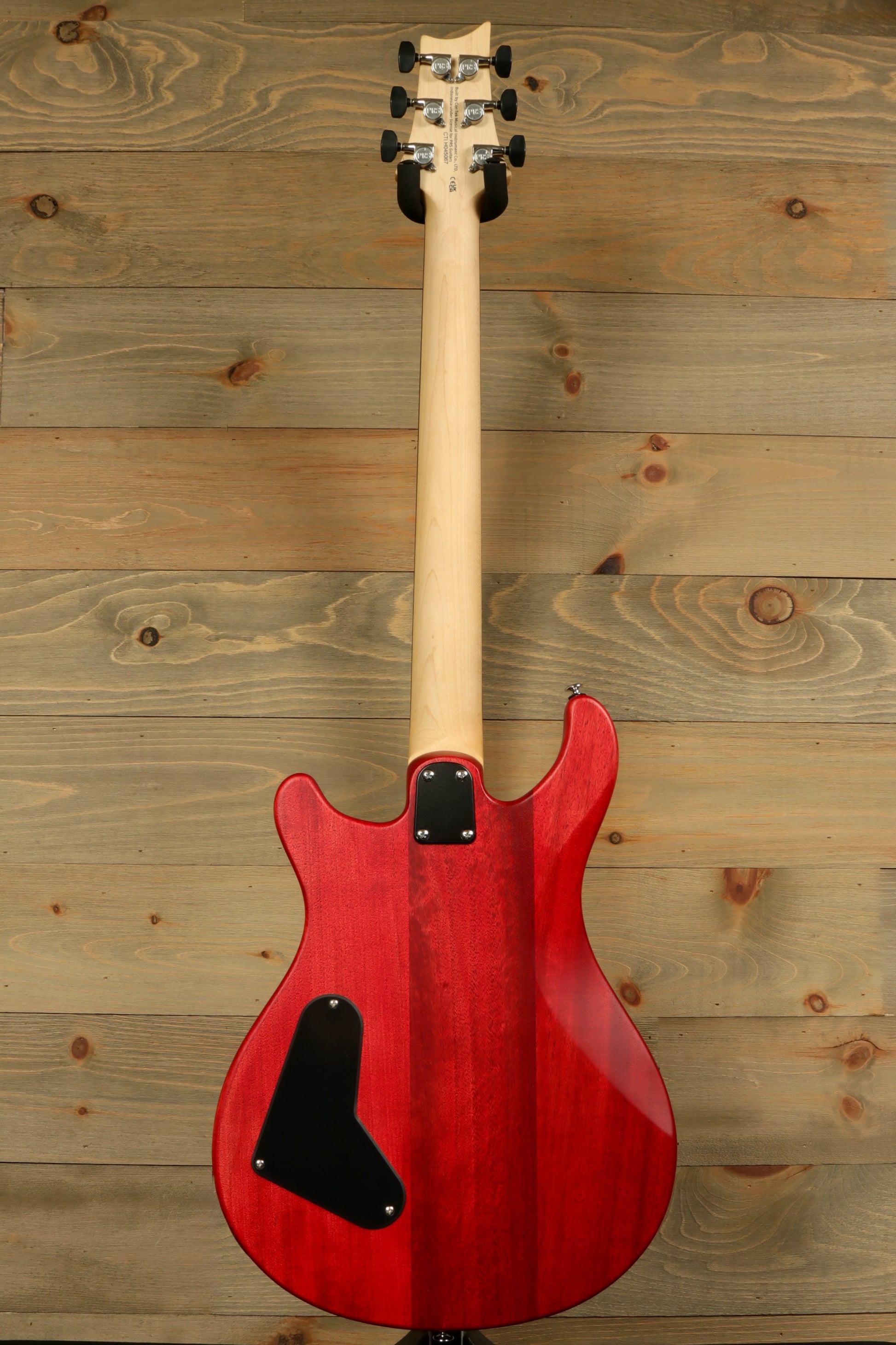 Back view of the PRS SE CE24 Standard Stoptail guitar showcasing its beautiful red finish and sleek design