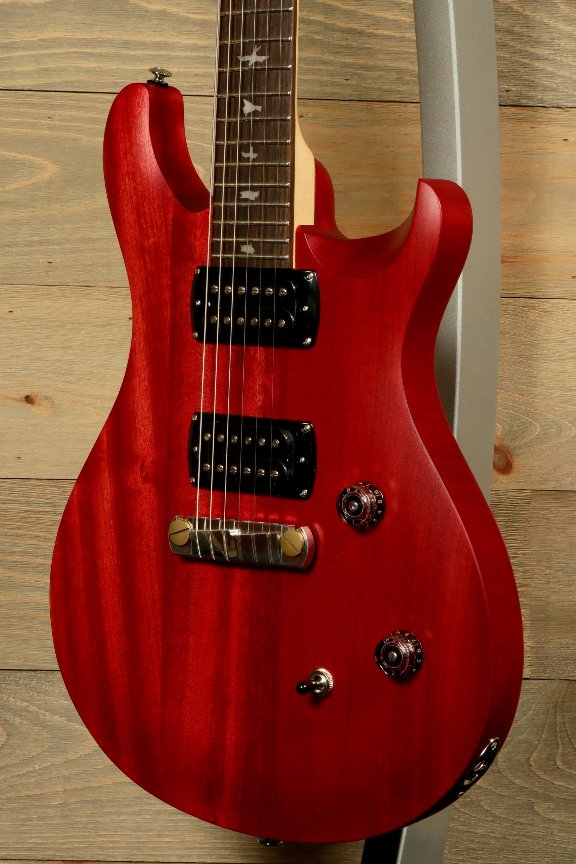 PRS SE CE24 Standard Stoptail guitar in red with dual pickups and sleek design