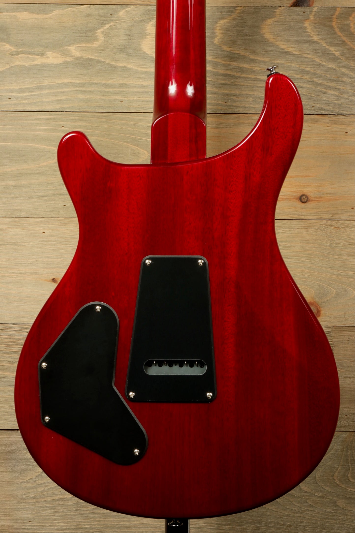 Back view of PRS SE DGT Standard guitar in vibrant red with sleek contours and black covers
