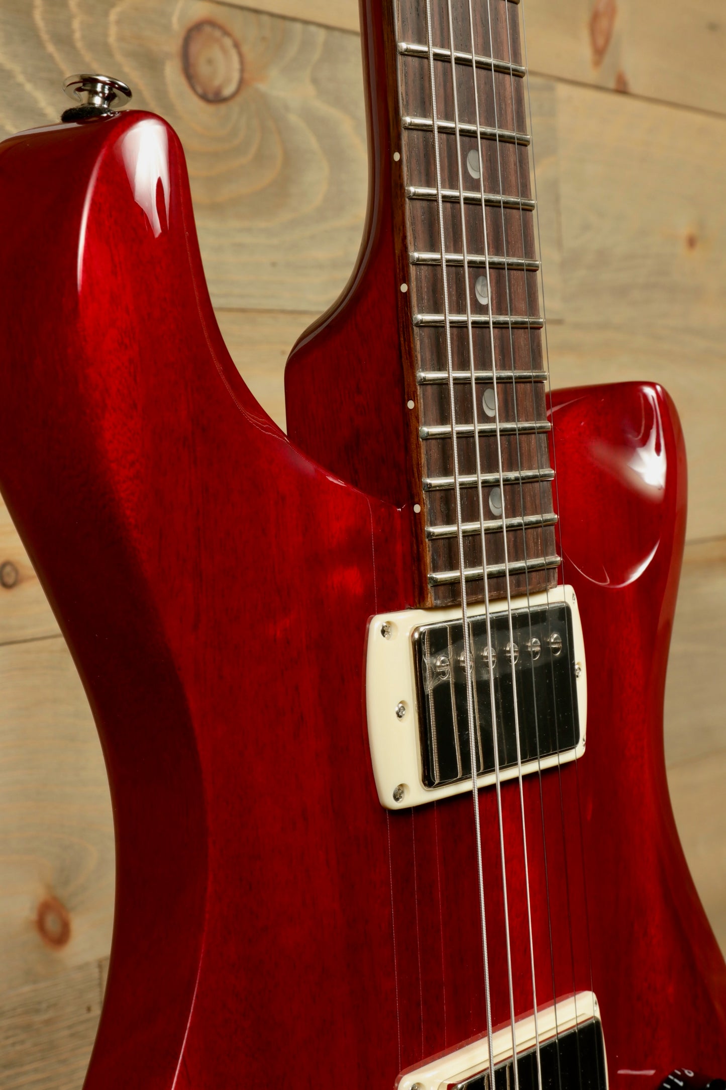 Close-up of PRS SE DGT Standard guitar in vibrant red with smooth finish and fretboard details