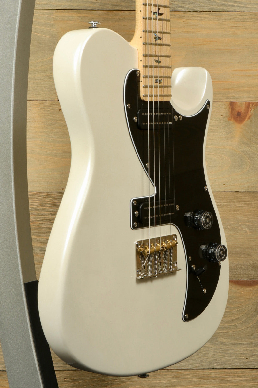 PRS SE NF53 in ivory white, side view showcasing sleek design and hardware