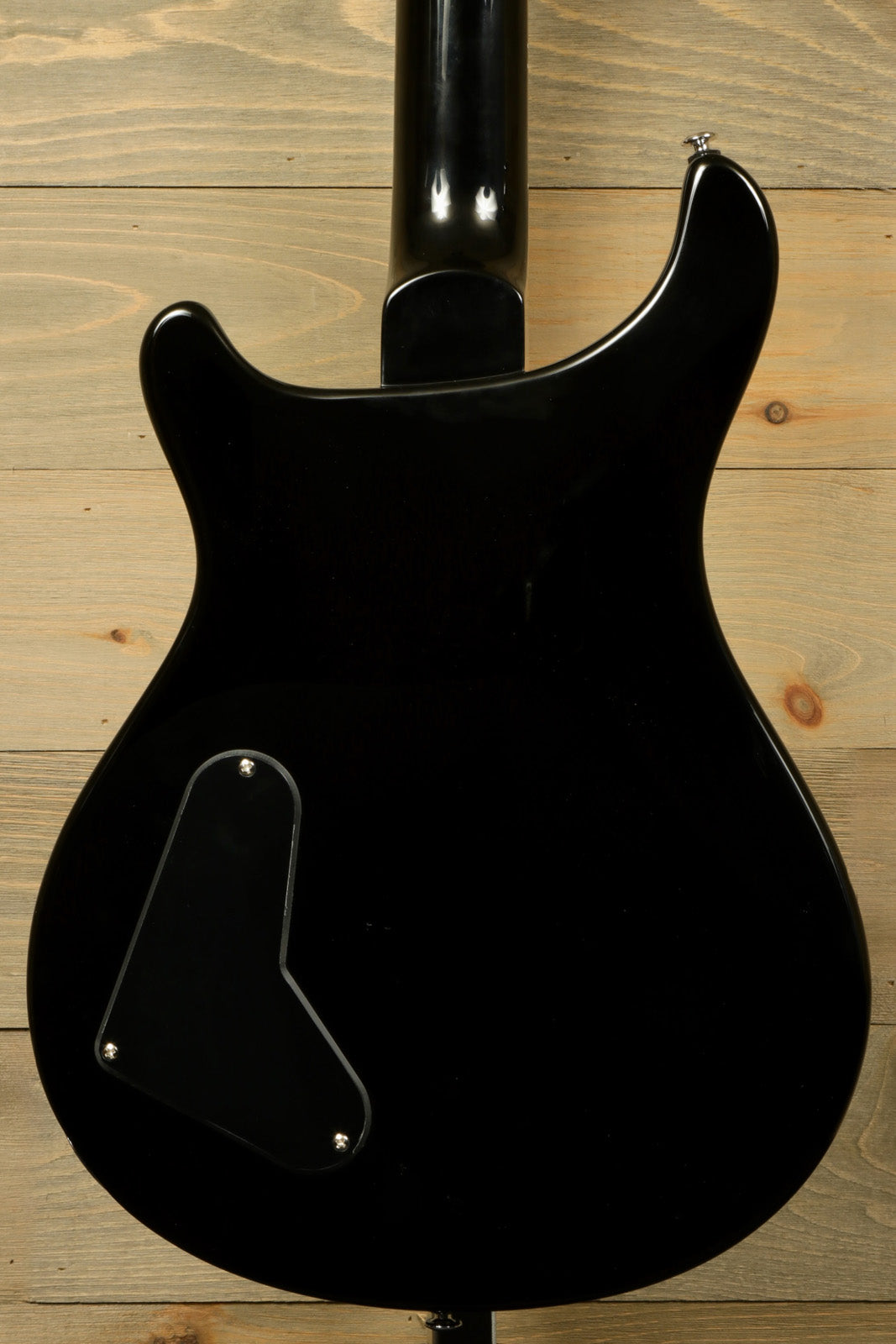 PRS SE Paul's Guitar in black, back view displaying the sleek finish and electronics cover