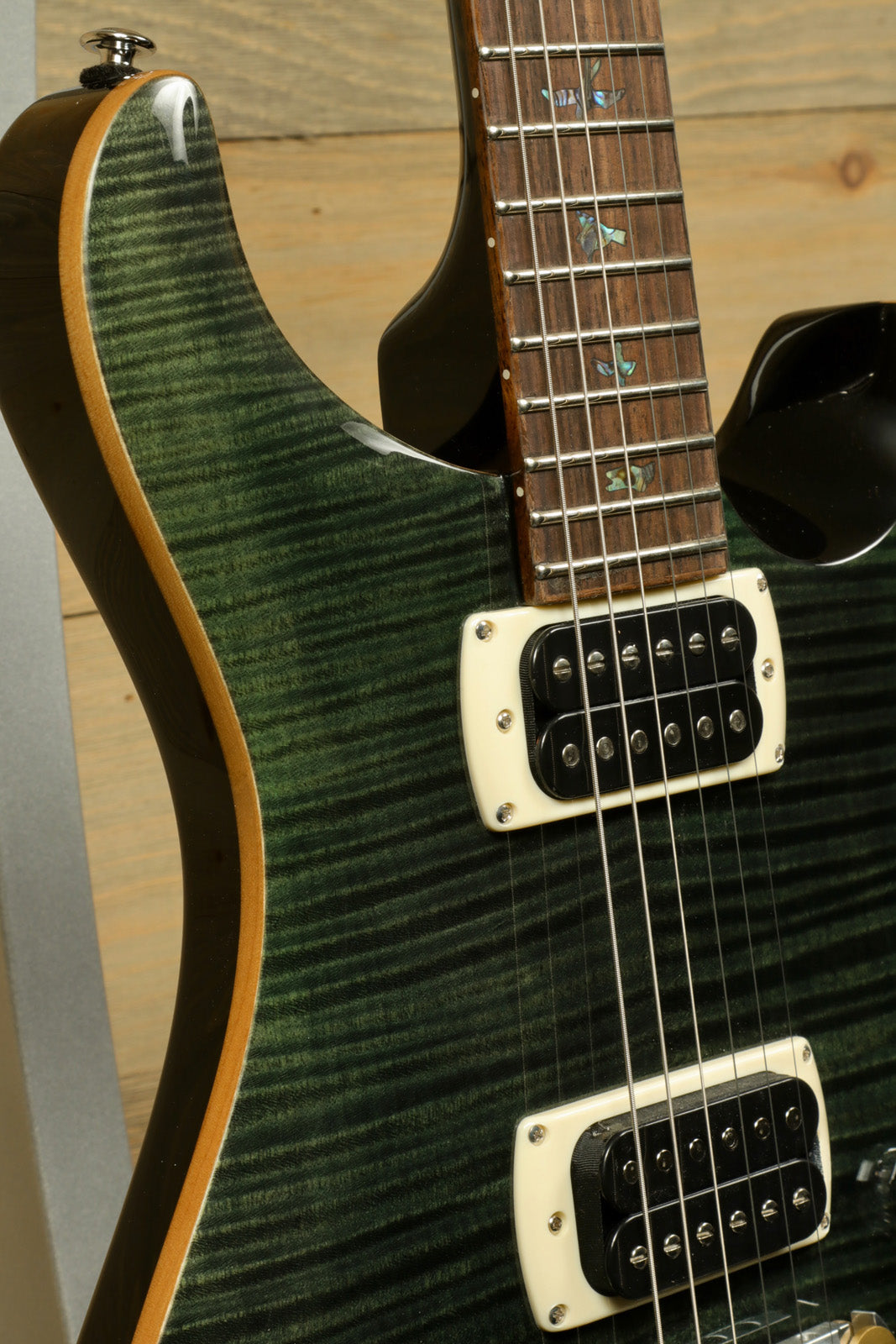 PRS SE Paul's Guitar in green flame top finish, angle view showcasing body and neck details