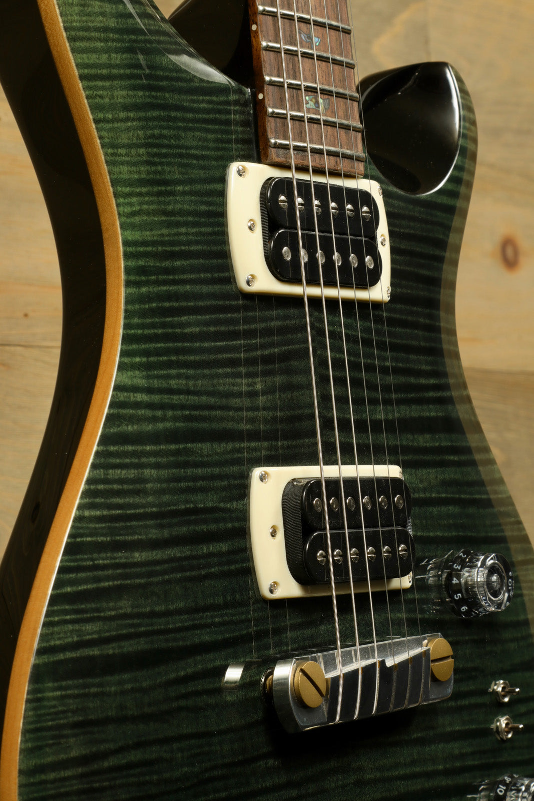 PRS SE Paul's Guitar green quilt finish, close-up view of body and neck detail