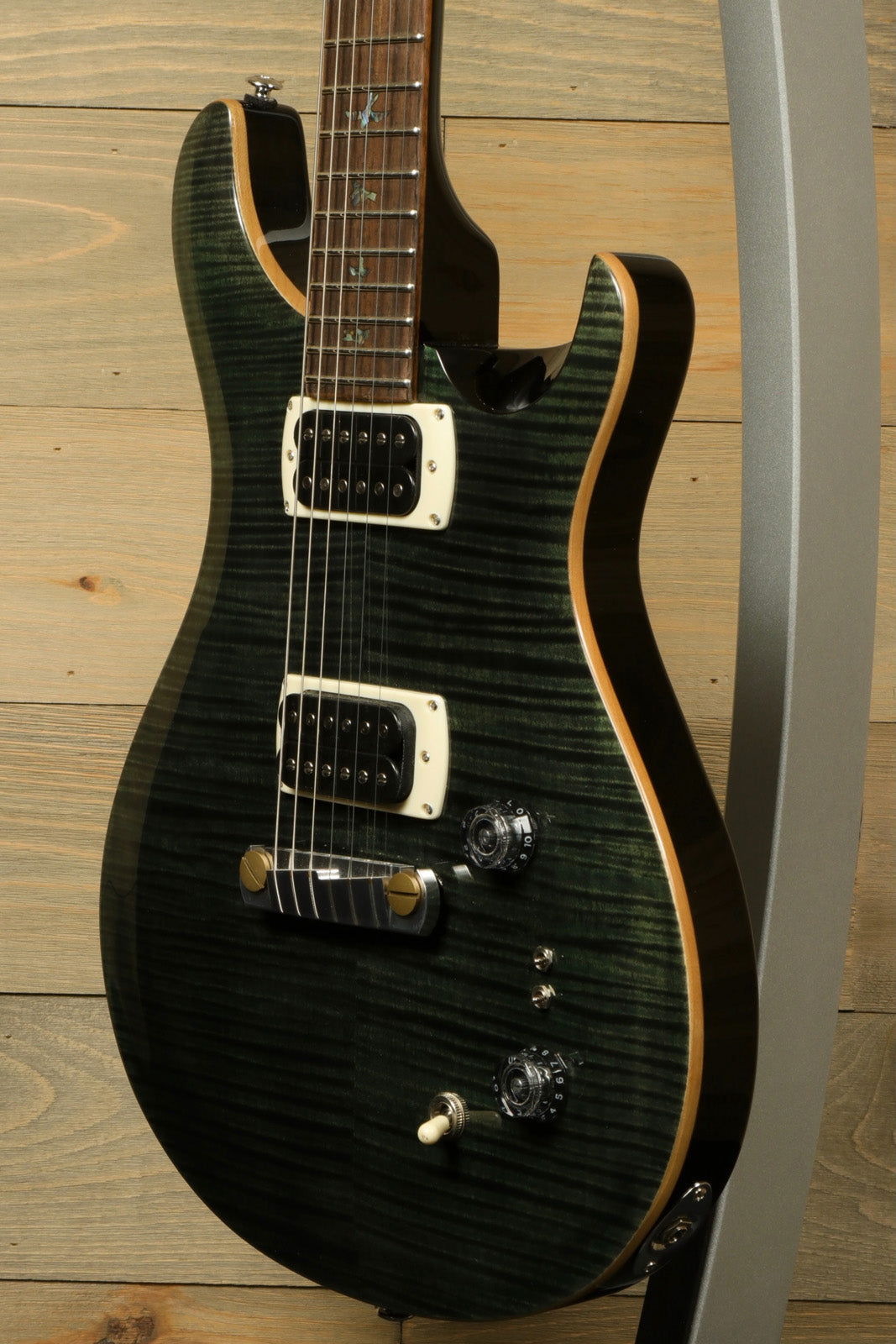 PRS SE Paul's Guitar in a dark green finish, front view showcasing the body and controls