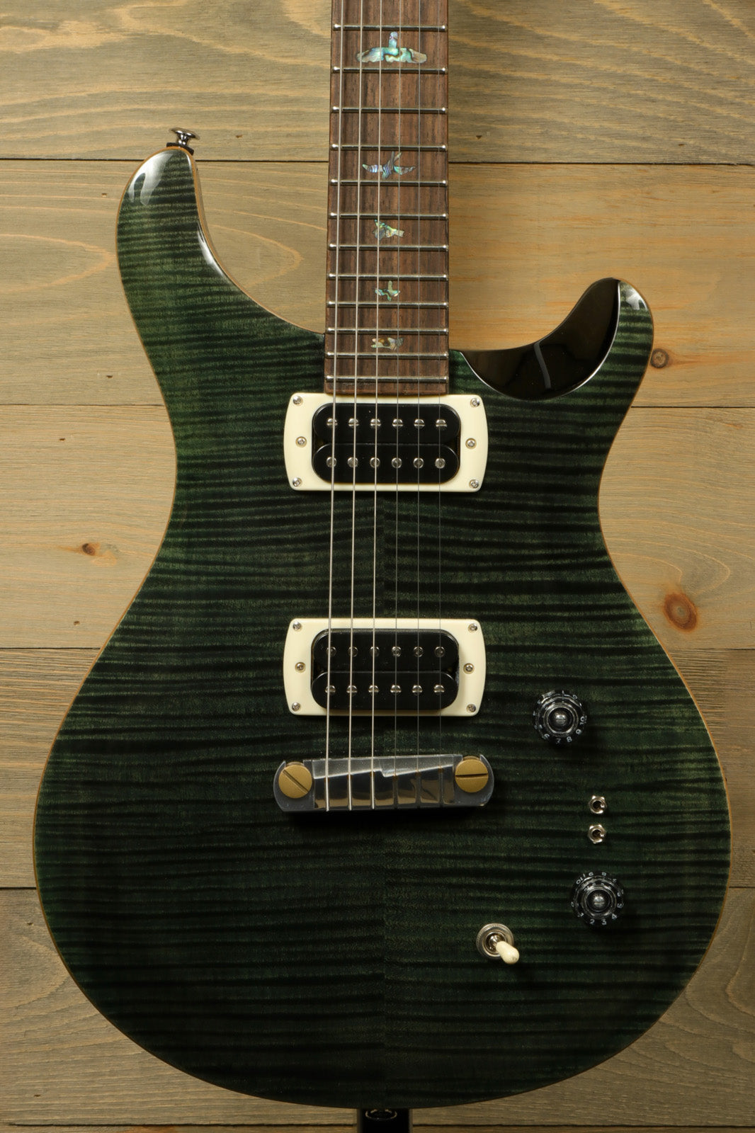 PRS SE Paul's Guitar in dark green with a flame finish, front view showcasing the fretboard and pickups