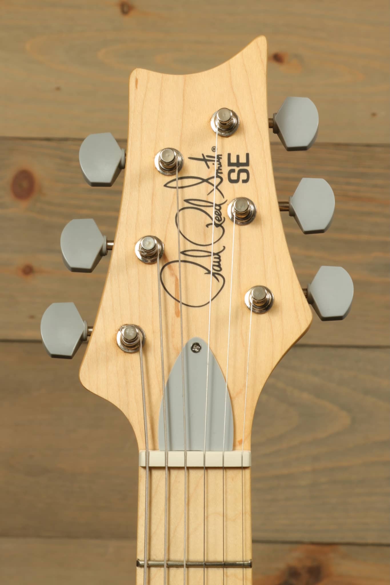 PRS SE Silver Sky - Moon White electric guitar headstock with six tuning pegs and signature design