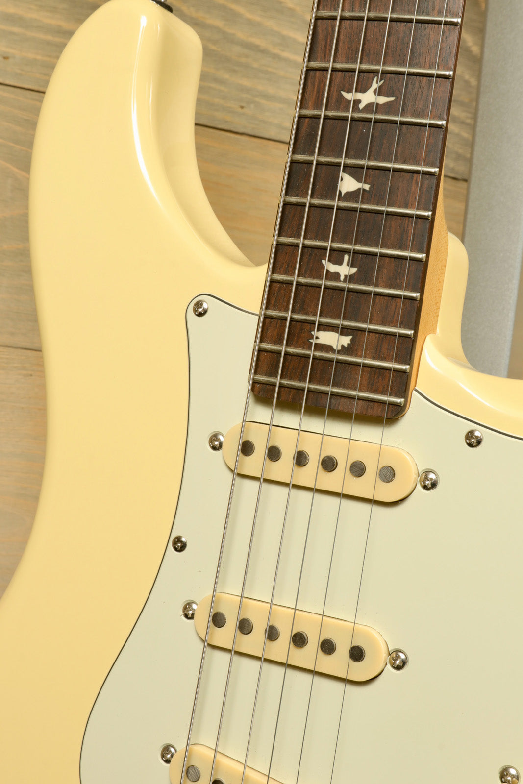 PRS SE Silver Sky in cream finish, front view with three single-coil pickups and decorative fret inlays - USED