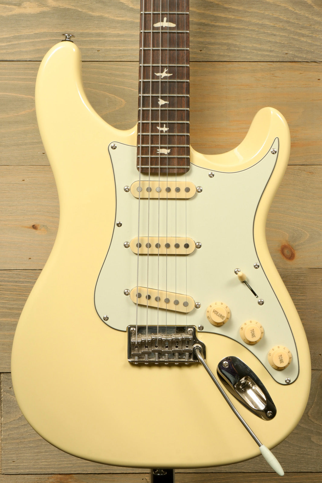 PRS SE Silver Sky in creamy white finish, front view with vintage-style pickups, used condition, includes gig bag