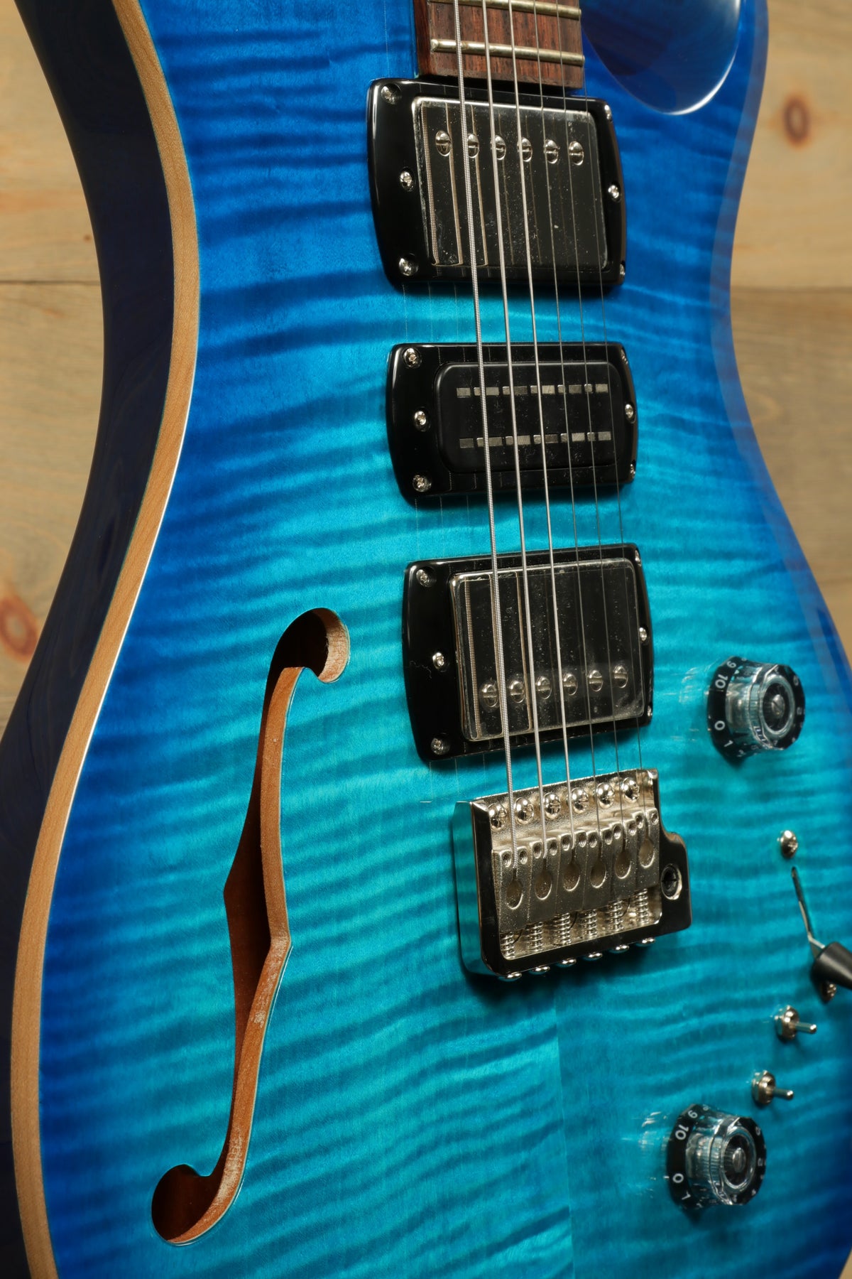 PRS SE Special Semi-Hollow electric guitar in vibrant blue, side view showcasing sleek design and pickups