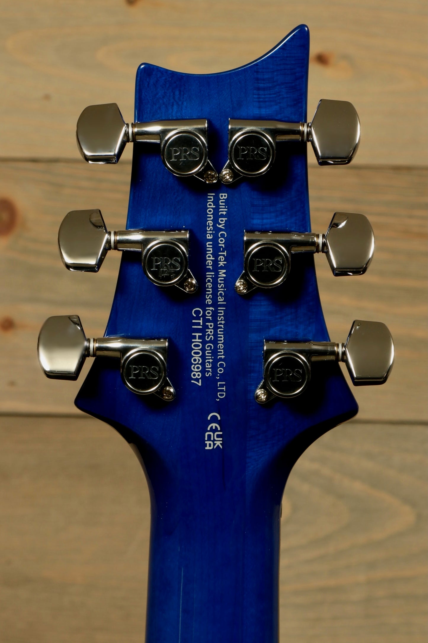 Back view of PRS SE Special Semi-Hollow electric guitar showcasing tuning pegs and vibrant blue finish