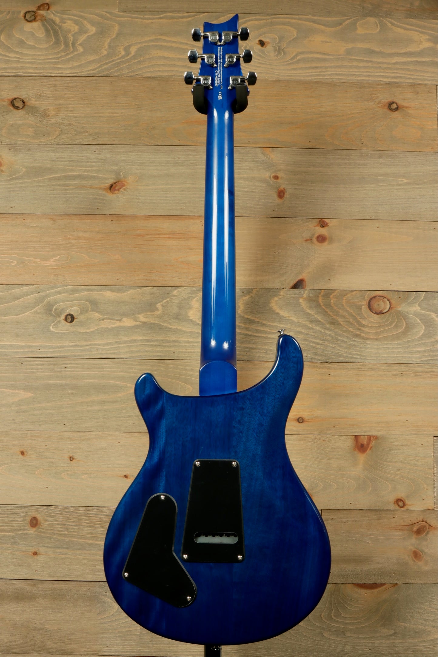 Back view of PRS SE Special Semi-Hollow electric guitar in blue with elegant curves and detailed finish