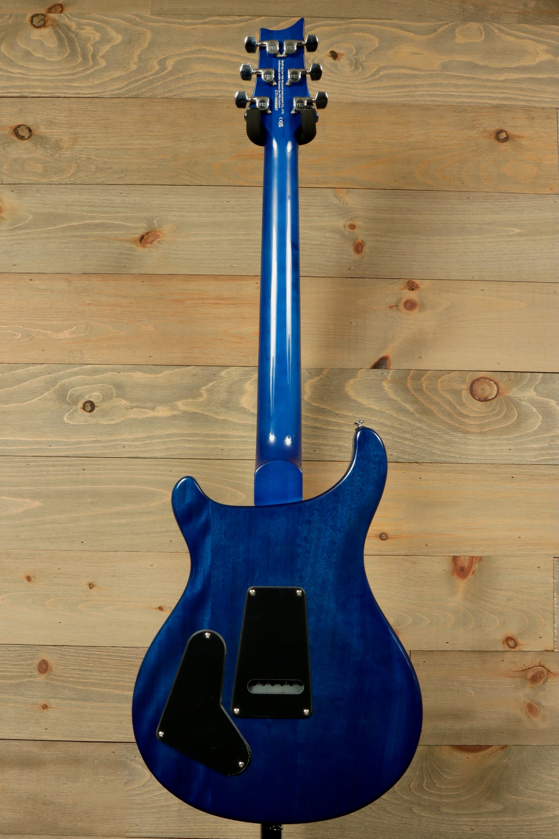 Back view of PRS SE Special Semi-Hollow electric guitar in blue with elegant curves and detailed finish