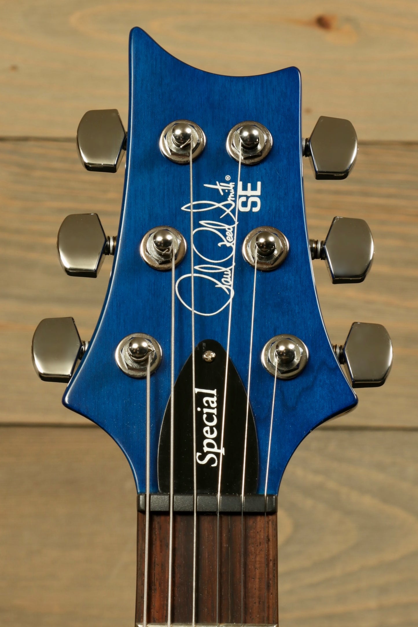 PRS SE Special Semi-Hollow electric guitar headstock with blue finish and signature detail