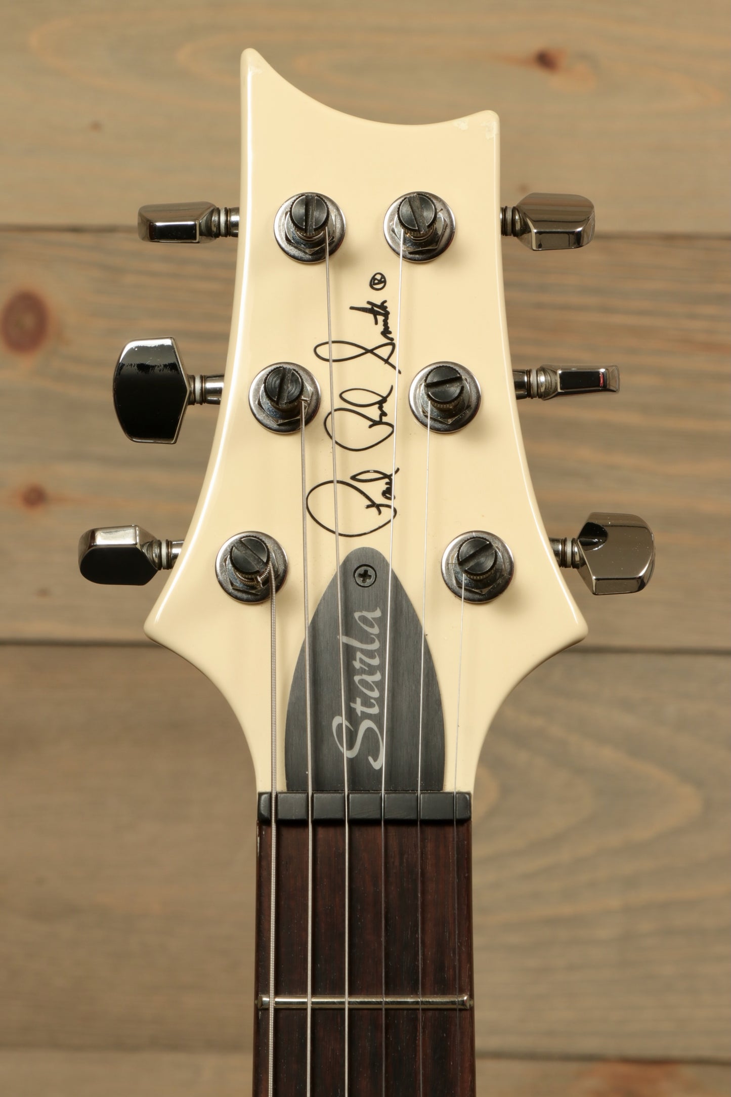 PRS Starla S2 electric guitar in cream color, close-up of headstock and tuning pegs