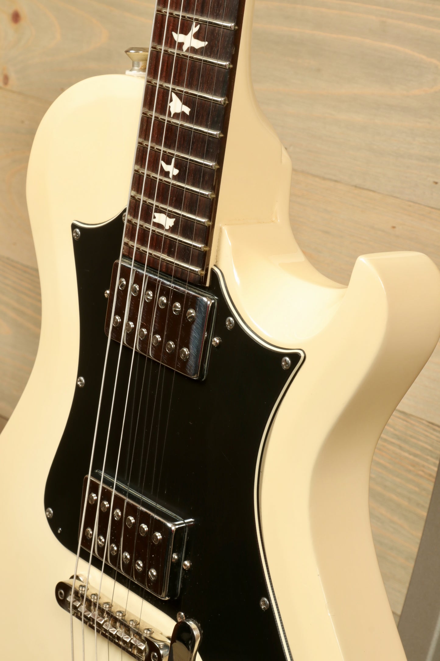 PRS Starla S2 in vintage white with black pickguard, angled front view highlighting the fretboard
