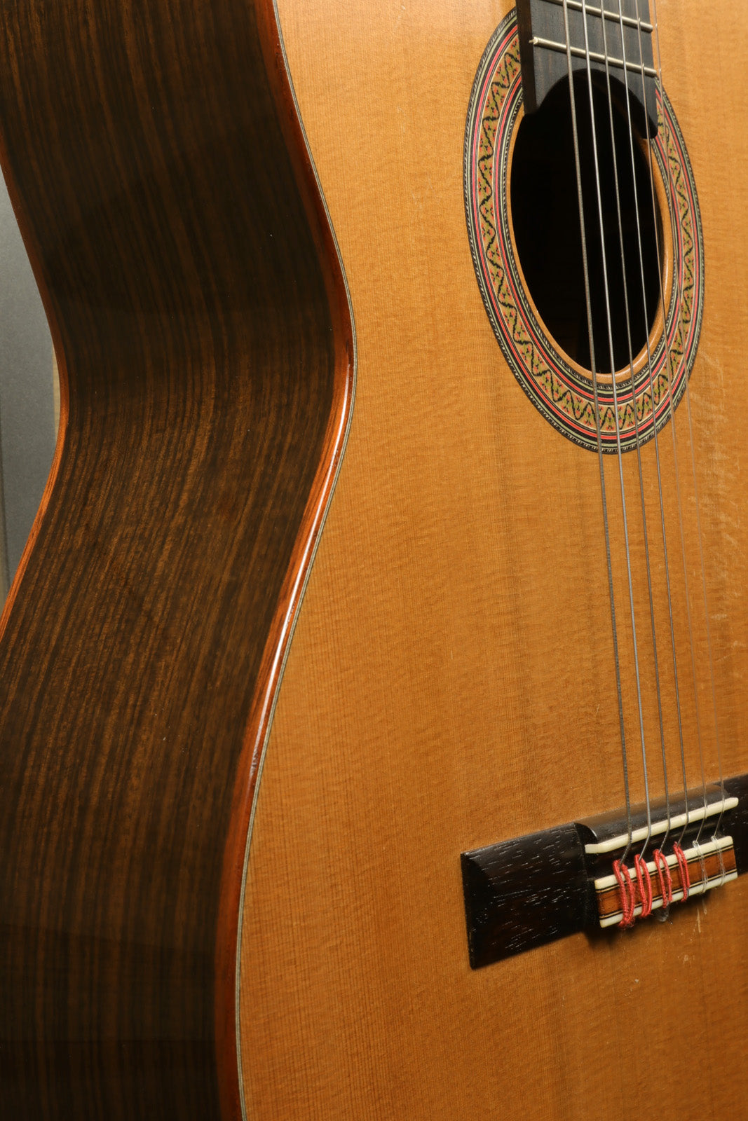 R. Thomas Rein Classical Concert Guitar with a natural wood finish, side view showcasing intricate detailing
