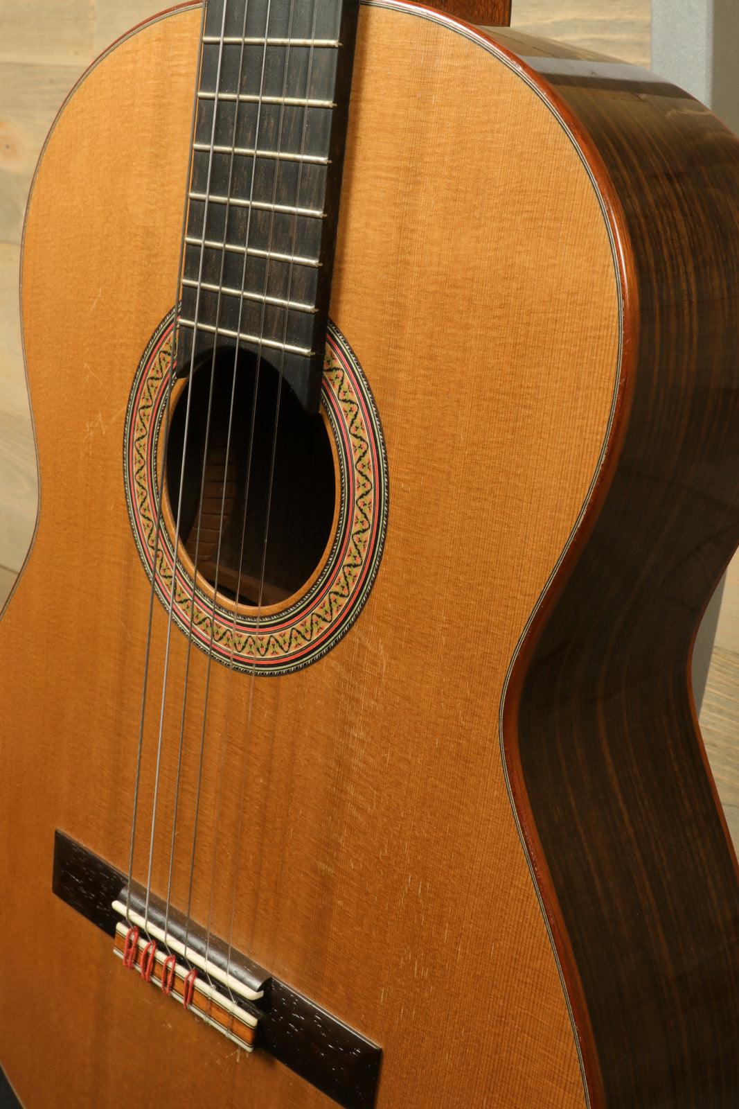 R. Thomas Rein Classical Concert Guitar, natural wood finish, side view highlighting intricate details.