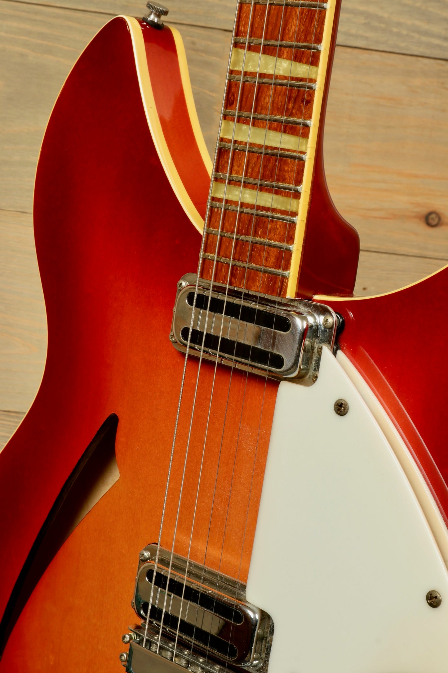 Rickenbacker 360 electric guitar in vibrant red finish, close-up of the body and neck