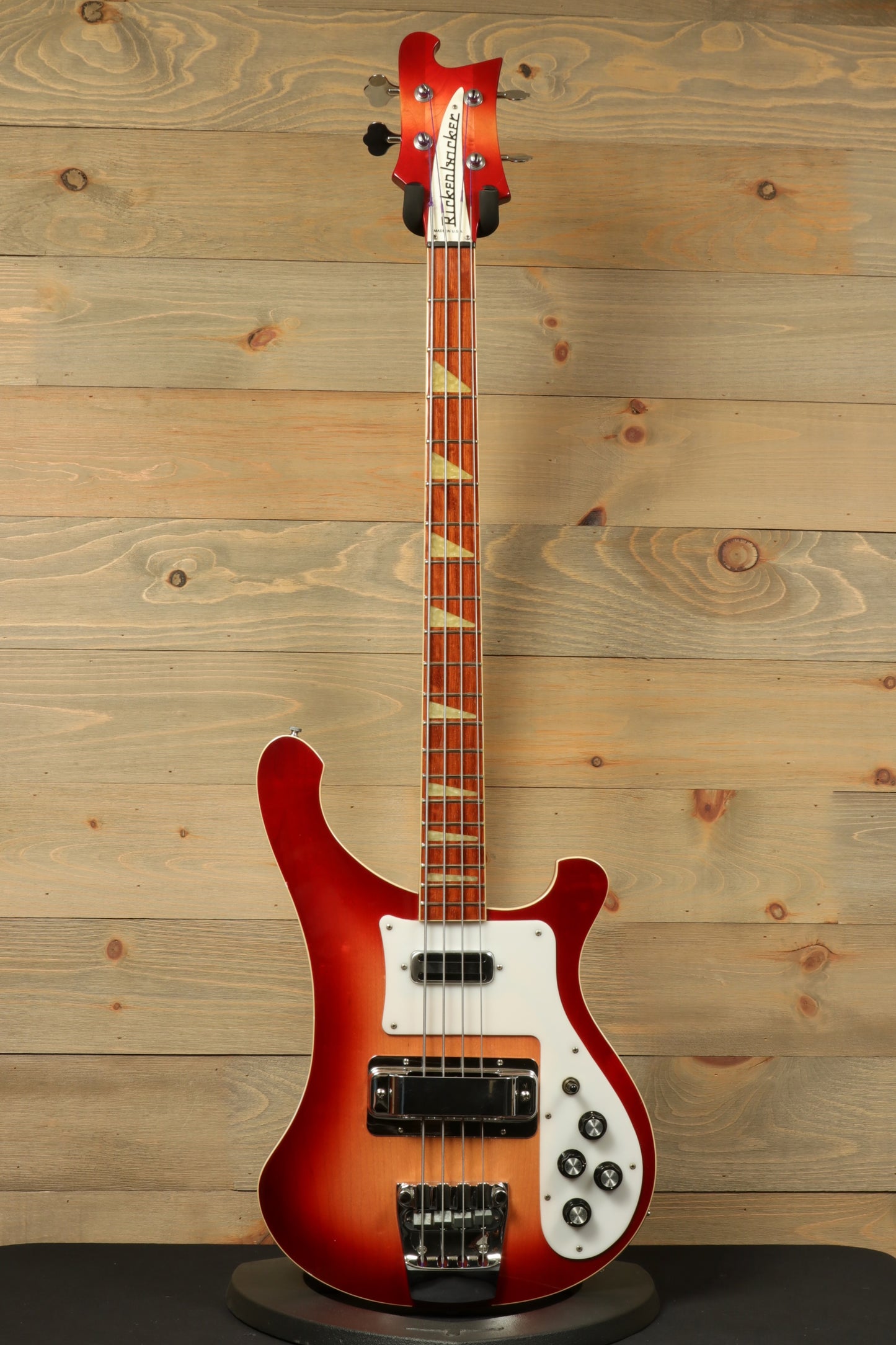 Rickenbacker 4001 bass guitars in fireglo finish, front view on wooden background