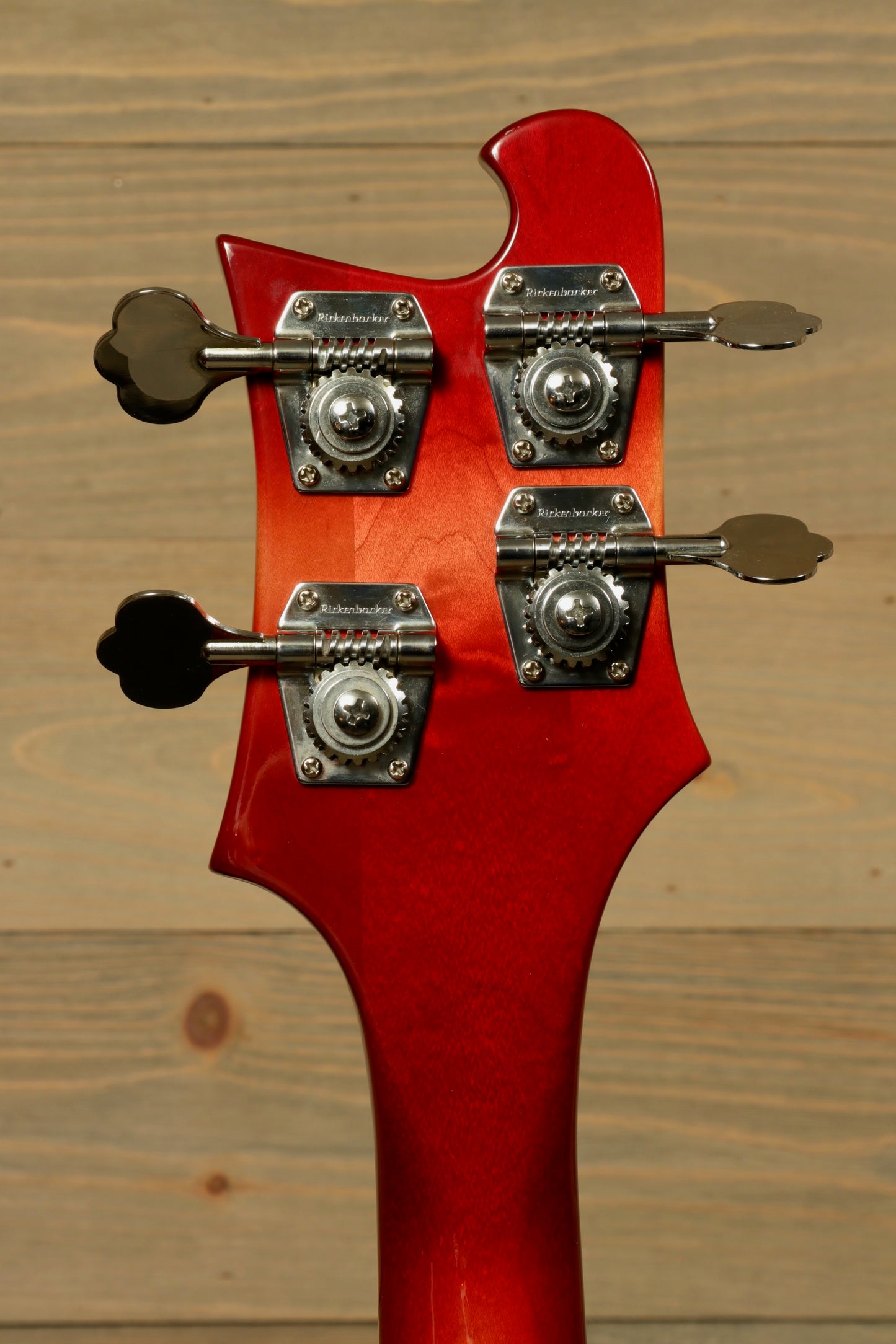 Rickenbacker 4001 bass guitar in red, back view showing tuning pegs and neck details