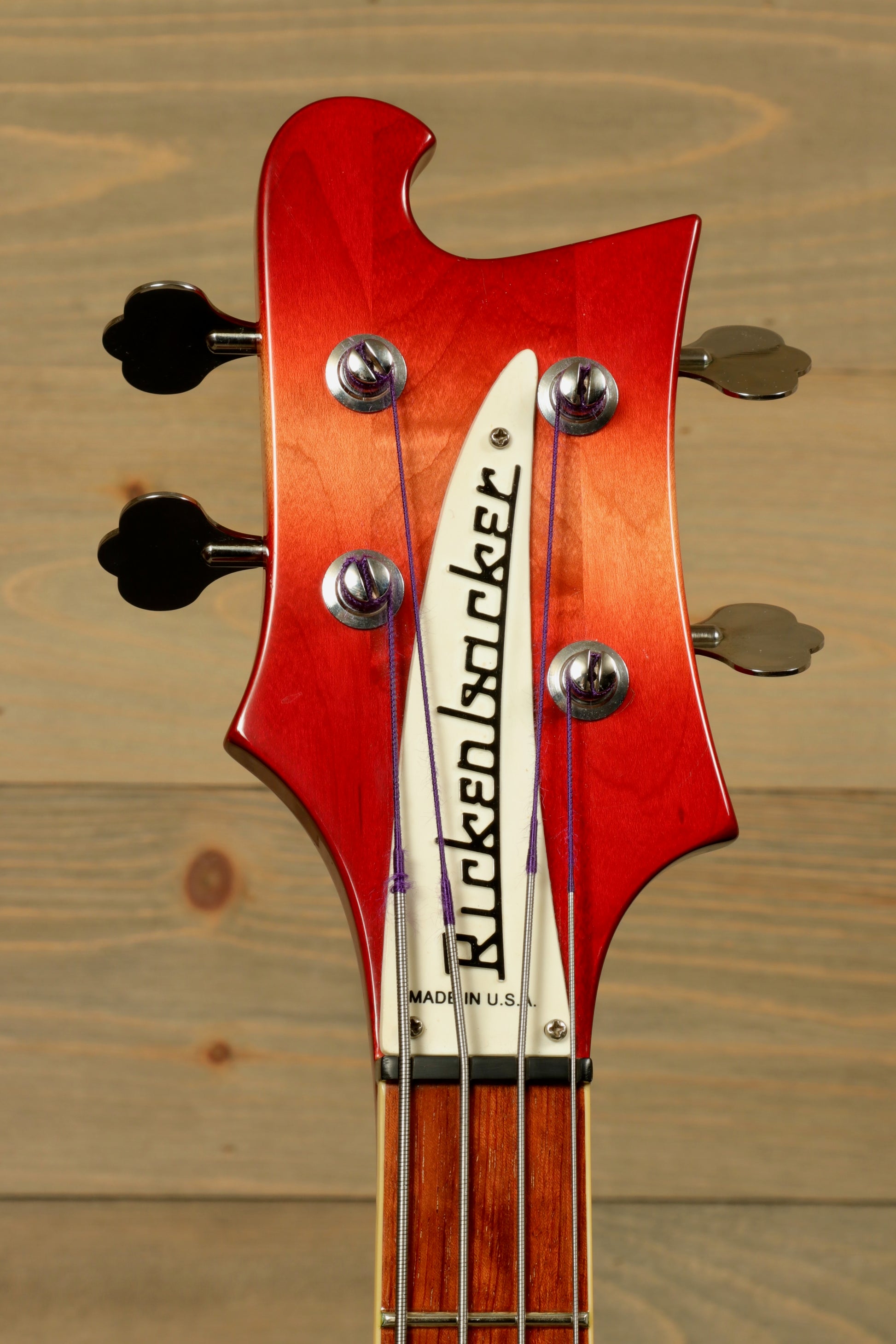 Rickenbacker 4001 bass guitars with a vivid red headstock, front view showcasing tuning pegs