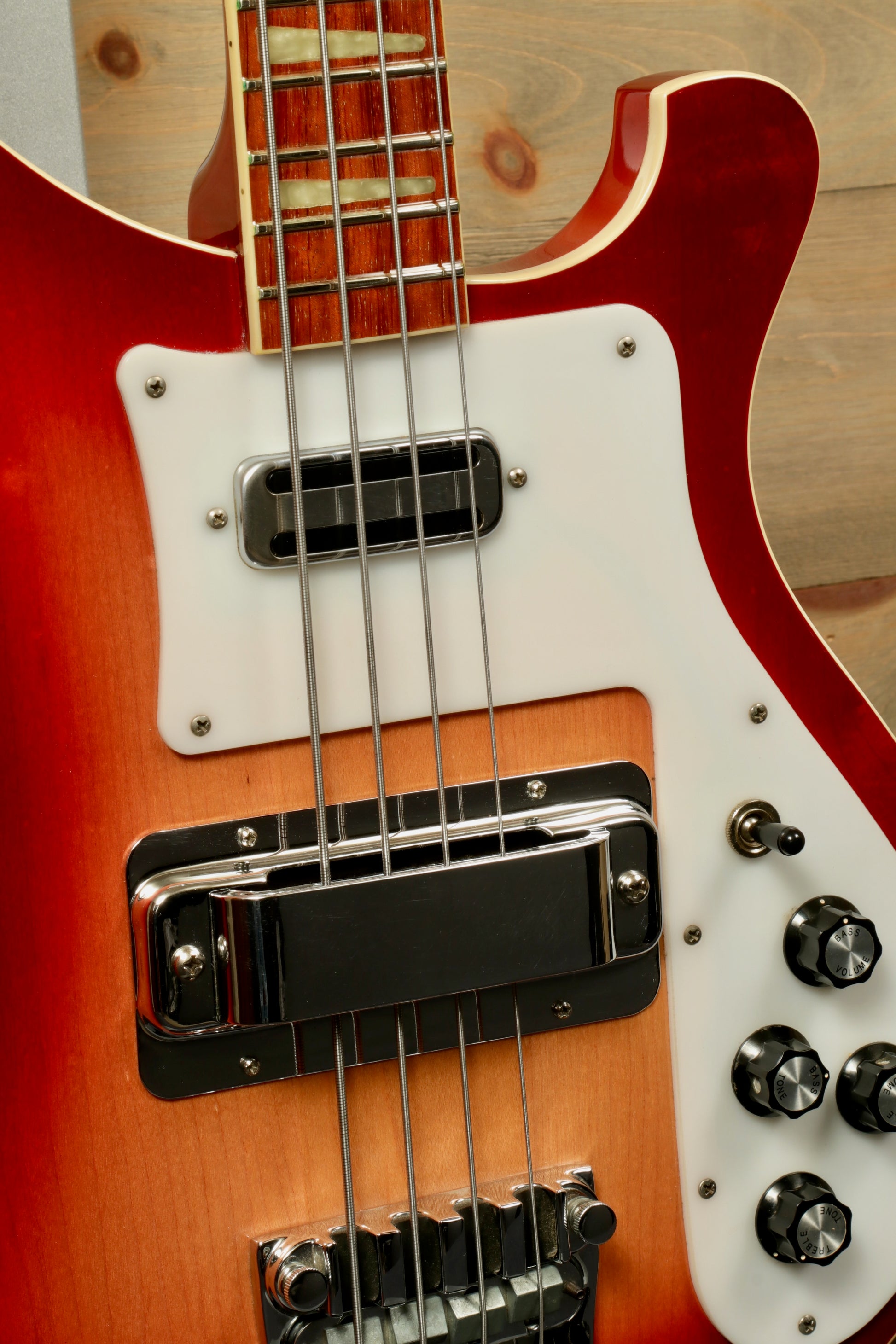 Rickenbacker 4001 bass guitars in fireglo finish, close-up view of the body and pickups