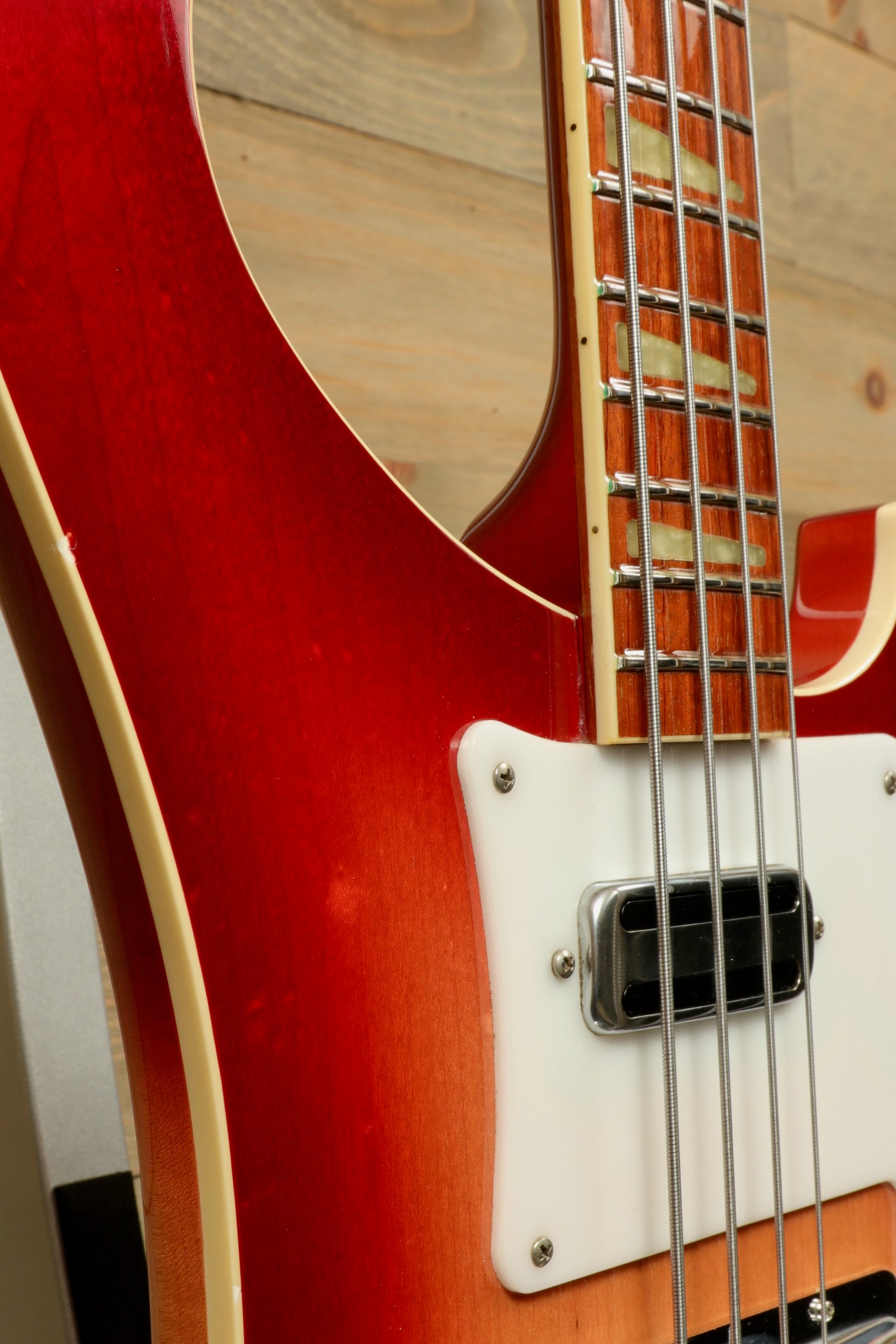 Rickenbacker 4001 bass guitar in a vibrant red finish, angled front view showcasing the body and neck