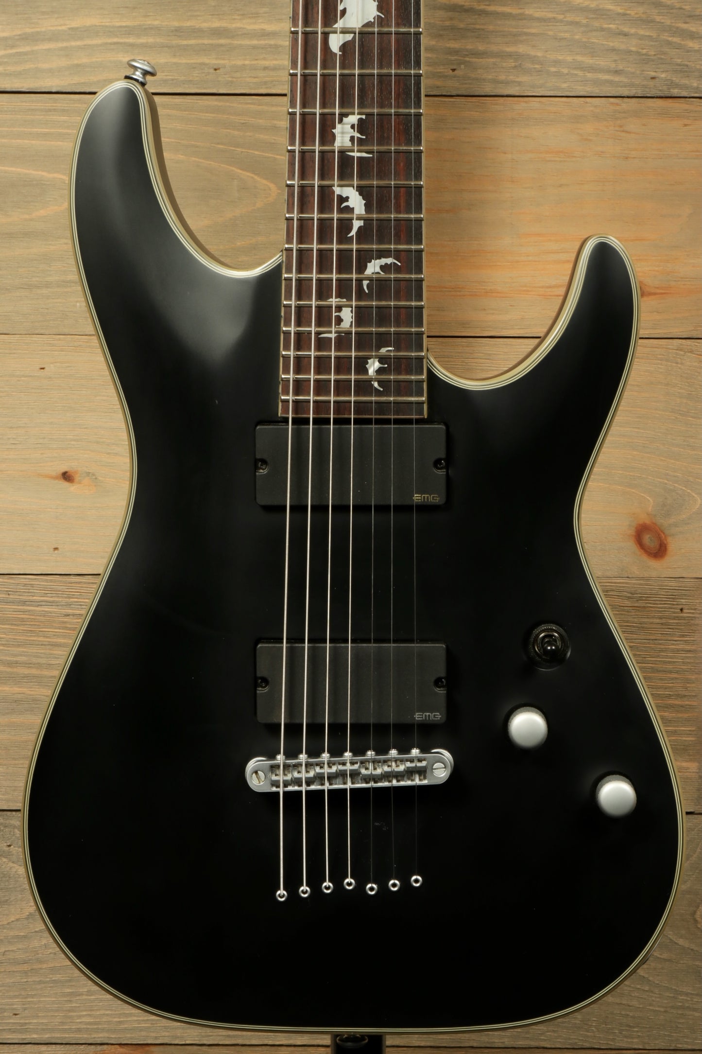 Used Schecter Damien 7 Platinum guitar with black finish and sleek design for versatile musicians