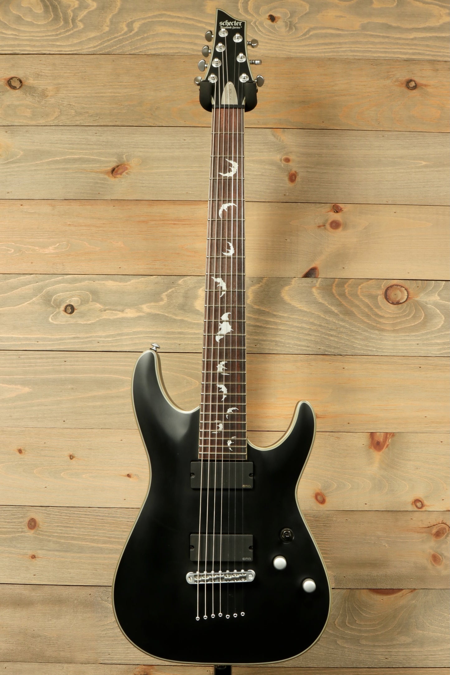 Used Schecter Damien 7 Platinum guitar in black finish with unique inlays and sleek design