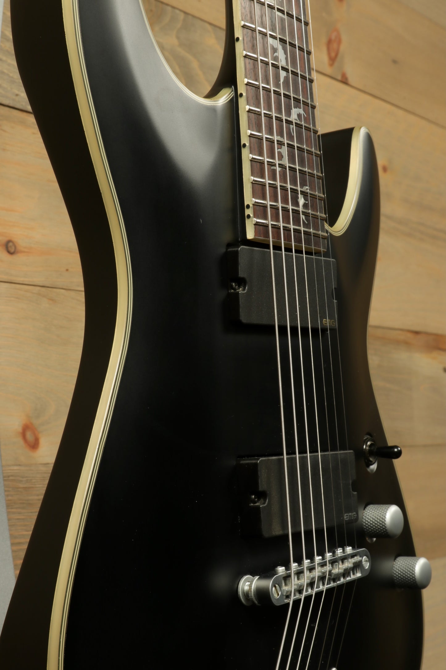 Close-up view of a used Schecter Damien 7 Platinum guitar showcasing its sleek design and features