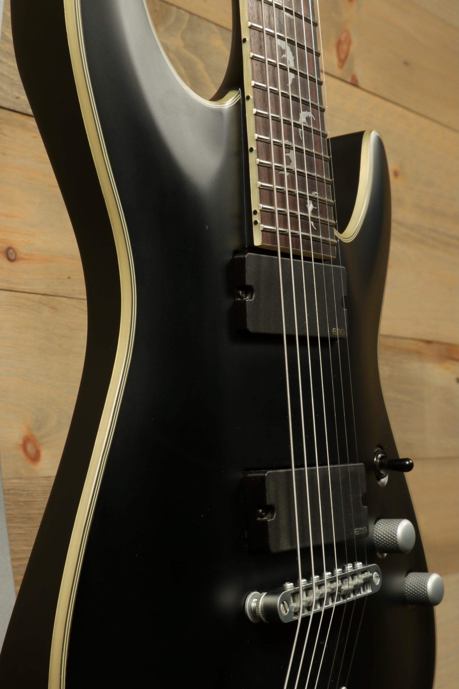 Close-up view of a used Schecter Damien 7 Platinum guitar showcasing its sleek design and features
