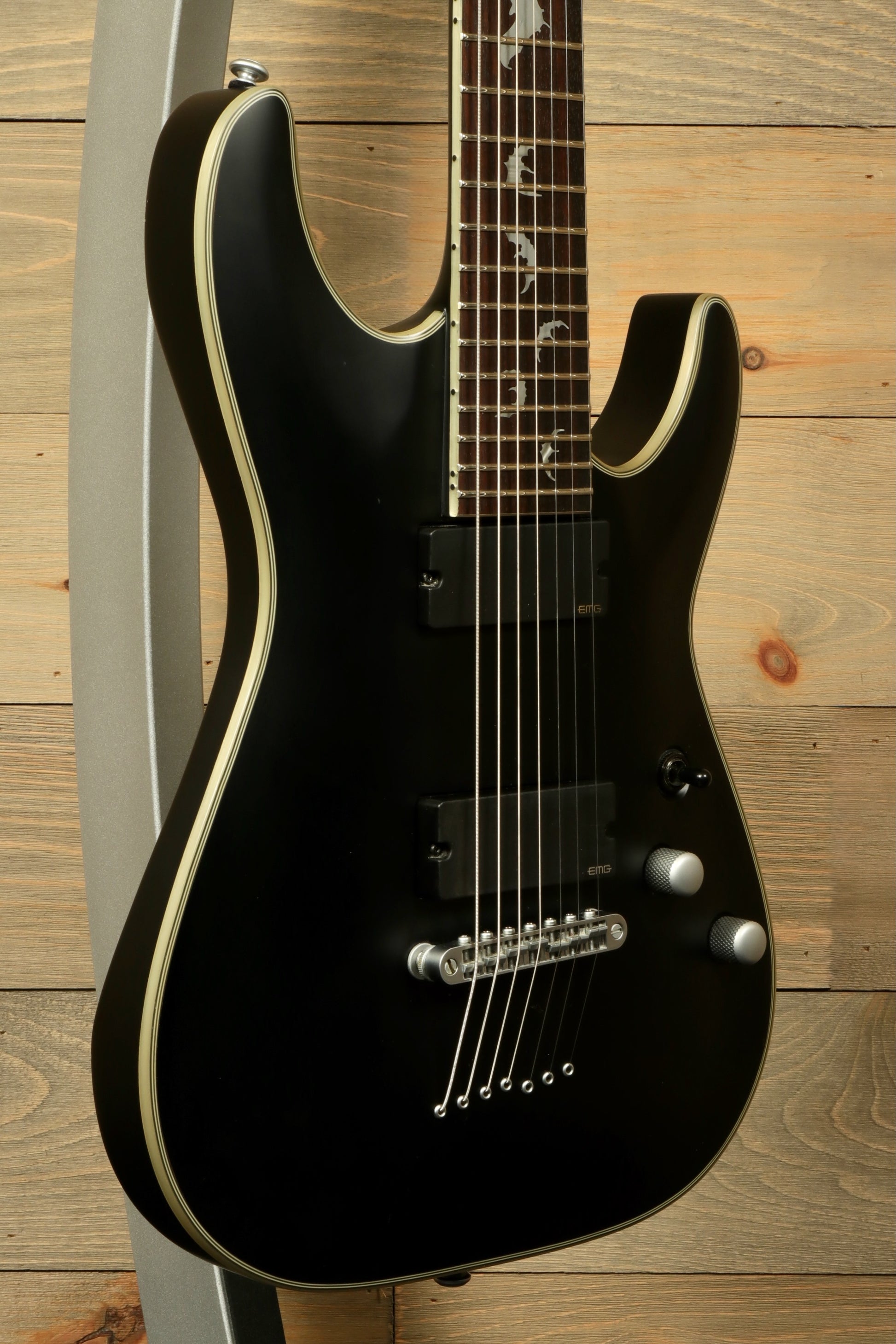 Used Schecter Damien 7 Platinum guitar in black finish with sleek body and dual pickups