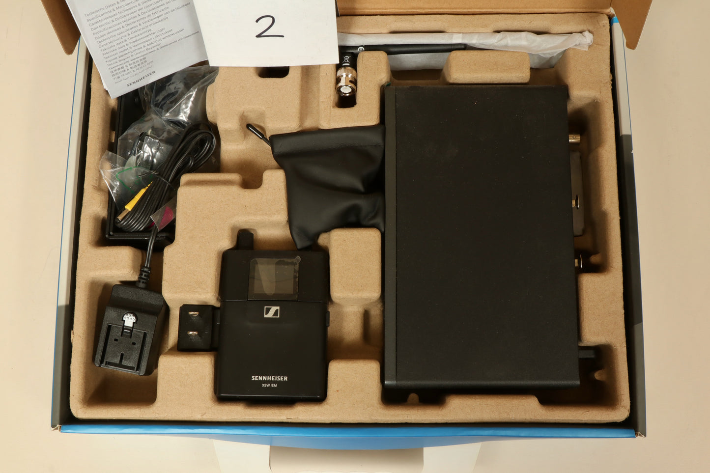 Sennheiser Wireless In Ear Monitors black case with accessories, top view showing components and organization