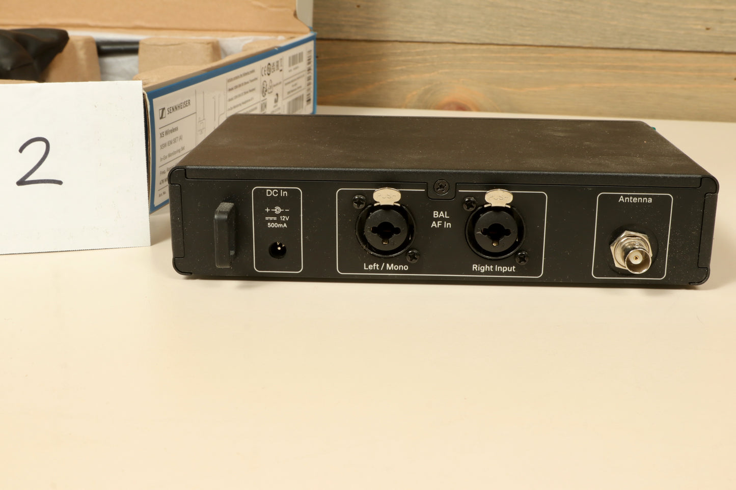 Sennheiser Wireless In Ear Monitors transmitter in black, rear view with audio inputs and antenna