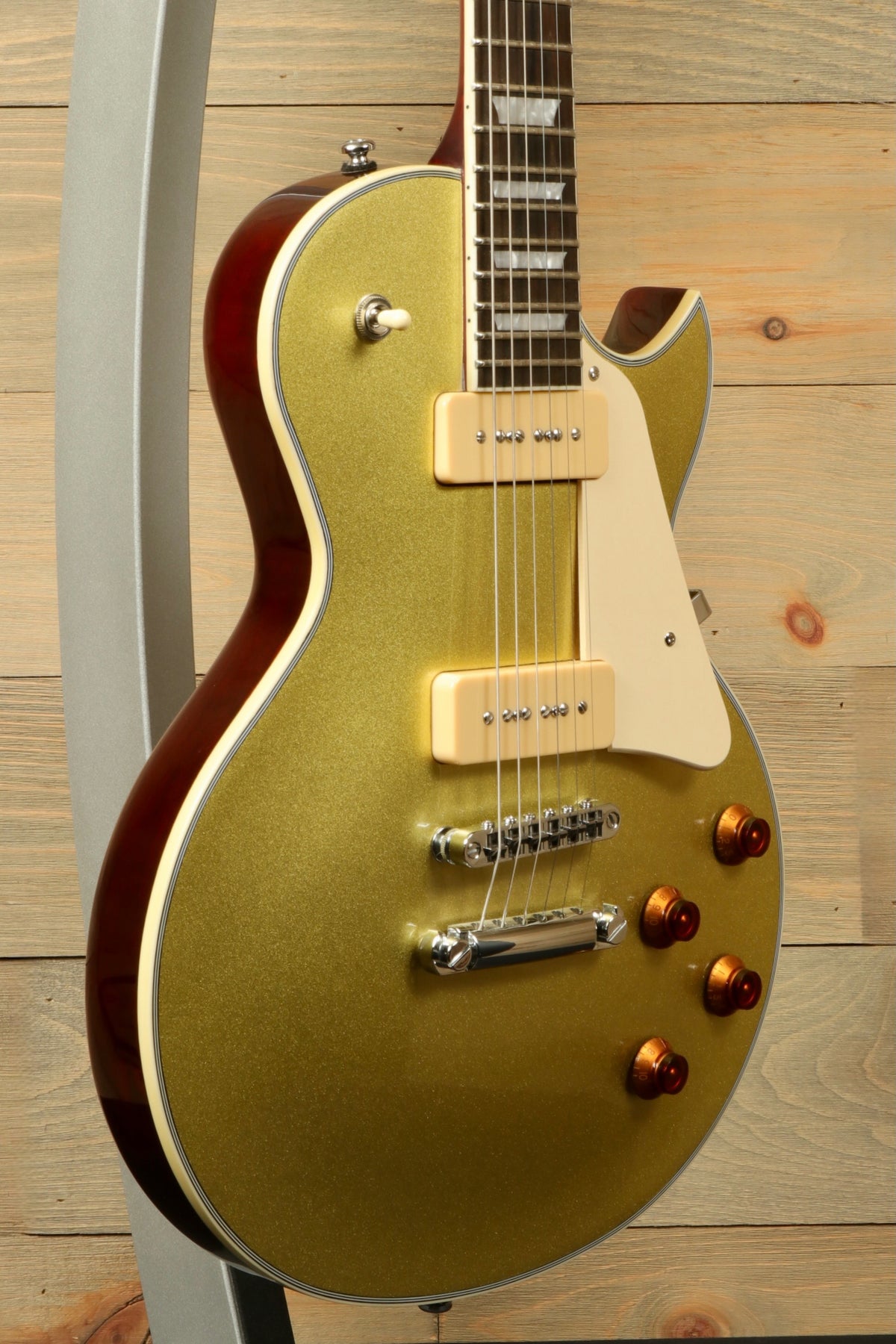 Sire Electric Guitar Goldtop, gold finish with dual pickups and control knobs, side view