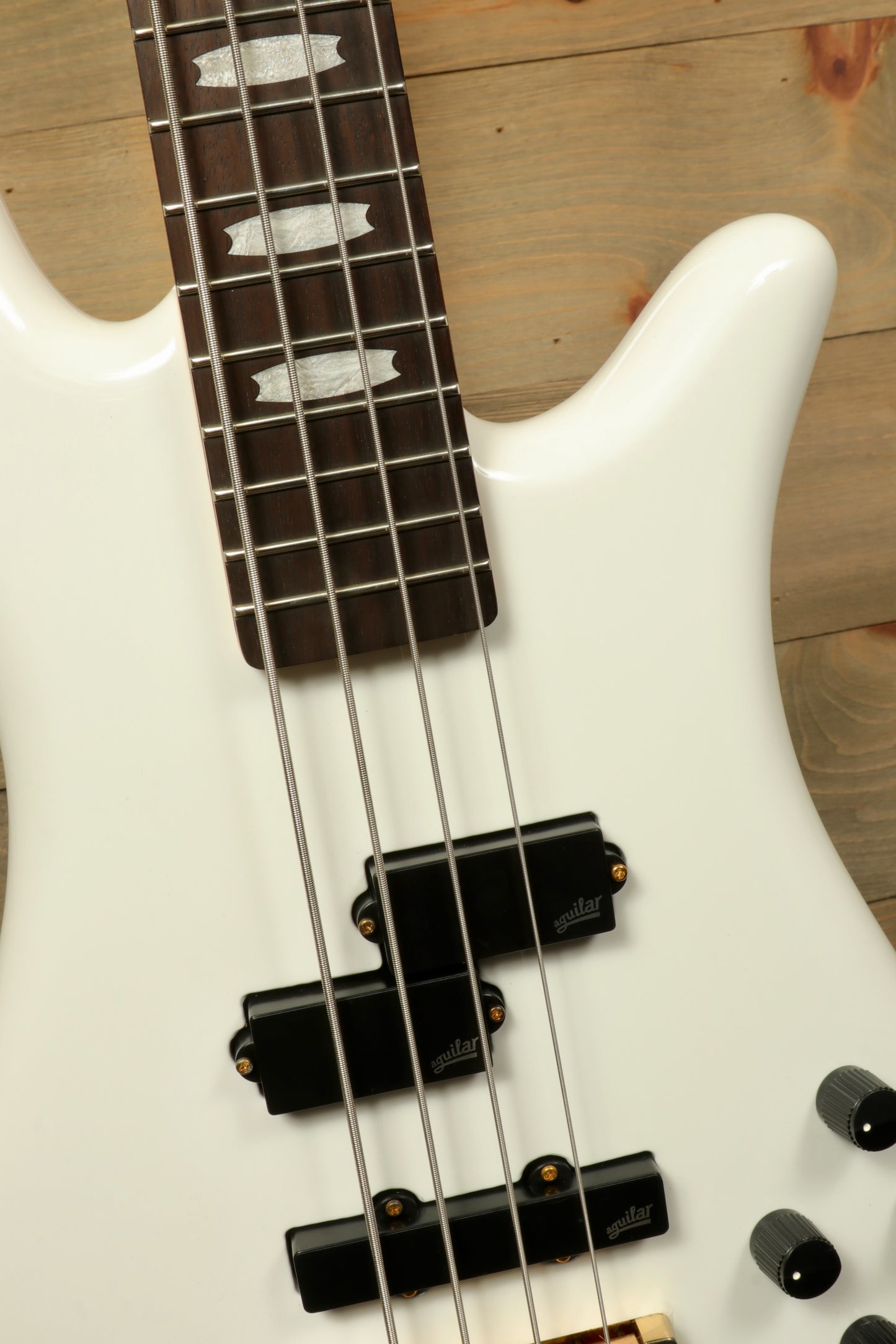 Close-up of Spector ICON NS-2 bass guitar with sleek white finish and detailed fretboard