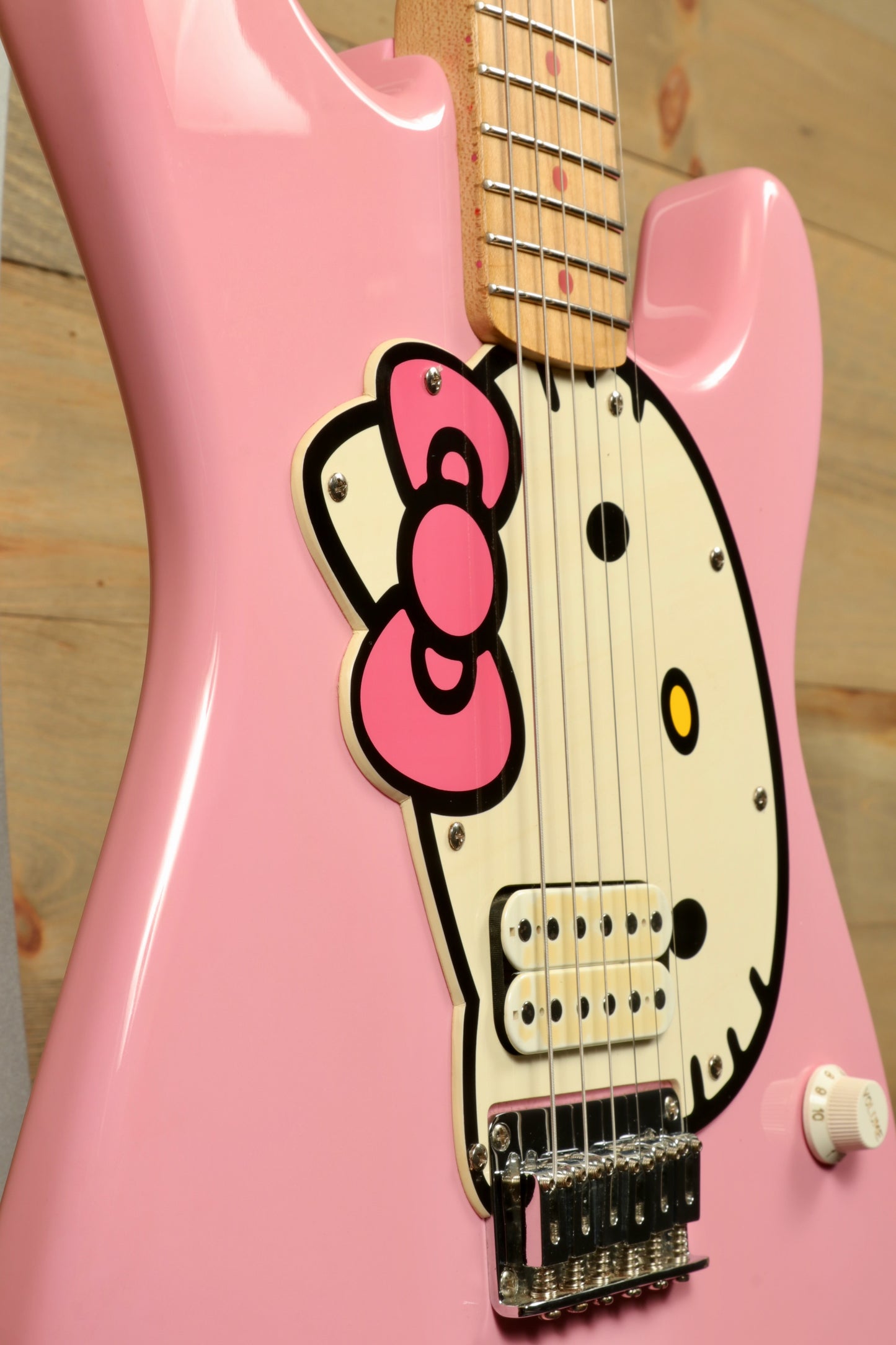 2006 Squier Hello Kitty Stratocaster electric guitar in pink with Hello Kitty design, close-up view