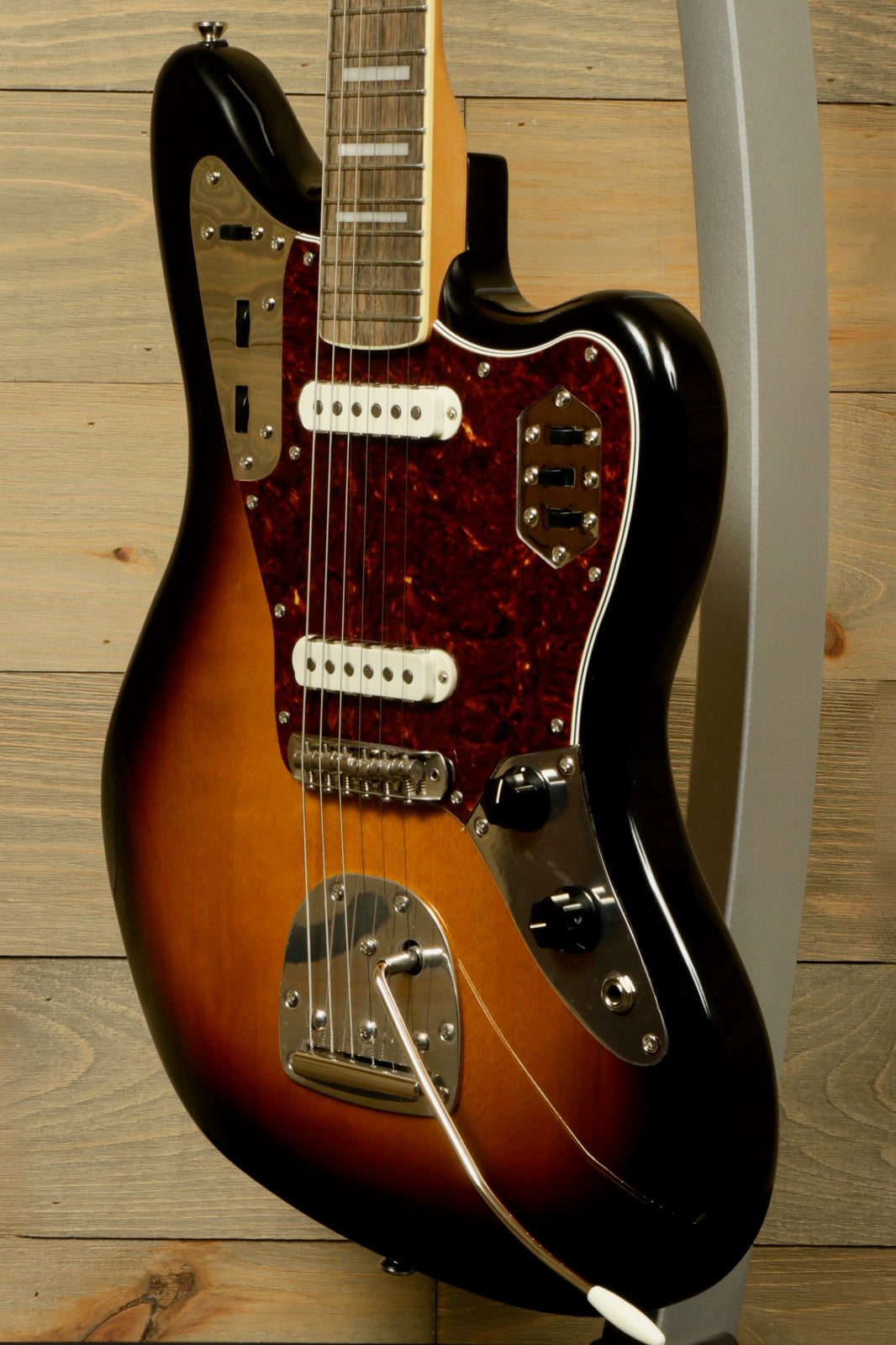 Squier Classic Vibe 70s Jaguar guitar in sunburst finish, side view with vintage-style pickups