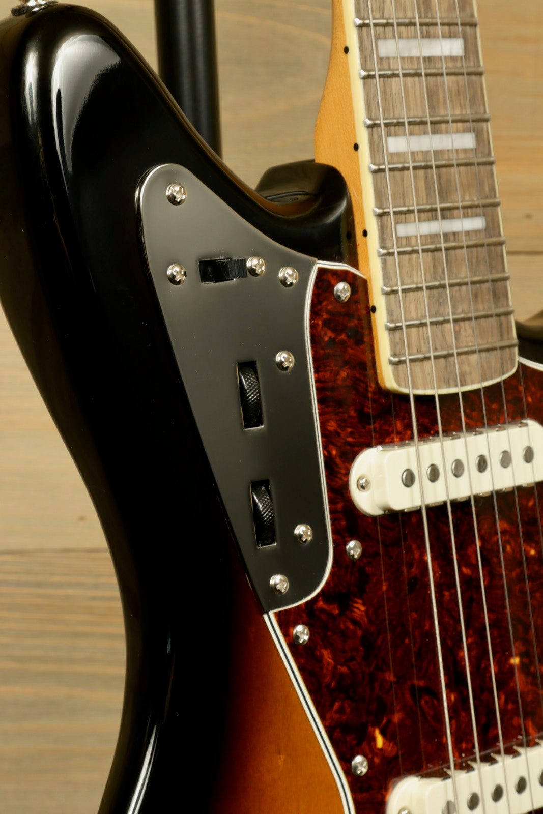 Squier Classic Vibe 70s Jaguar in sunburst finish, close-up view of controls and pickups
