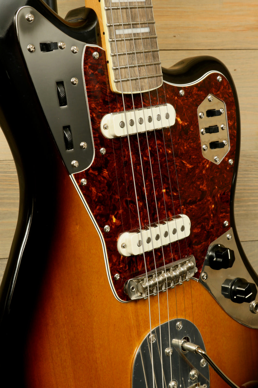 Squier Classic Vibe 70s Jaguar in sunburst finish, close-up view highlighting the pickups and neck