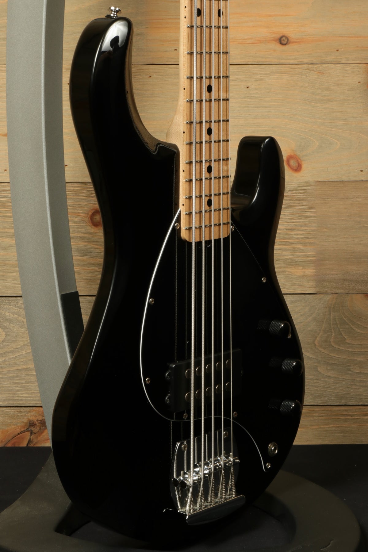 Sterling by Music Man black used active 5 string bass guitar, side view showcasing the sleek design