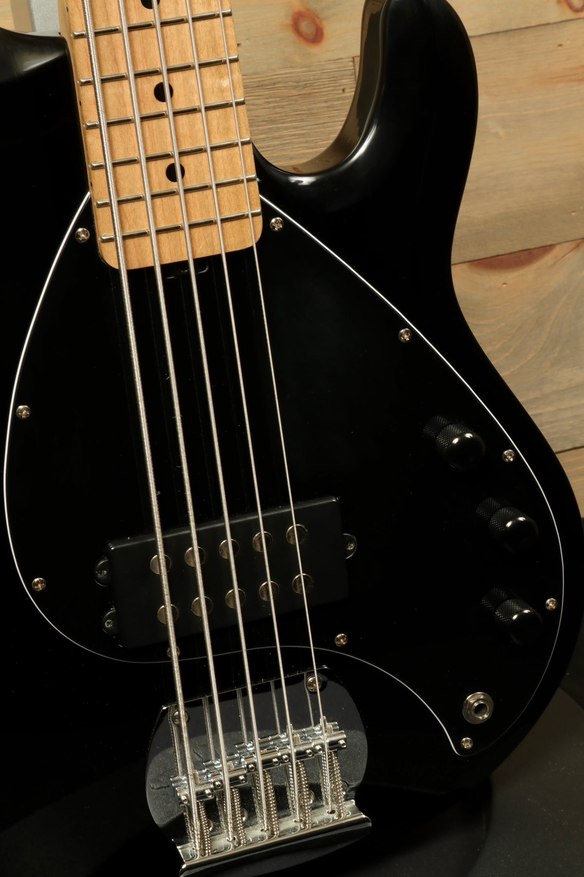 Sterling by Music Man used active 5 string bass in black, front view showcasing the body and pickups