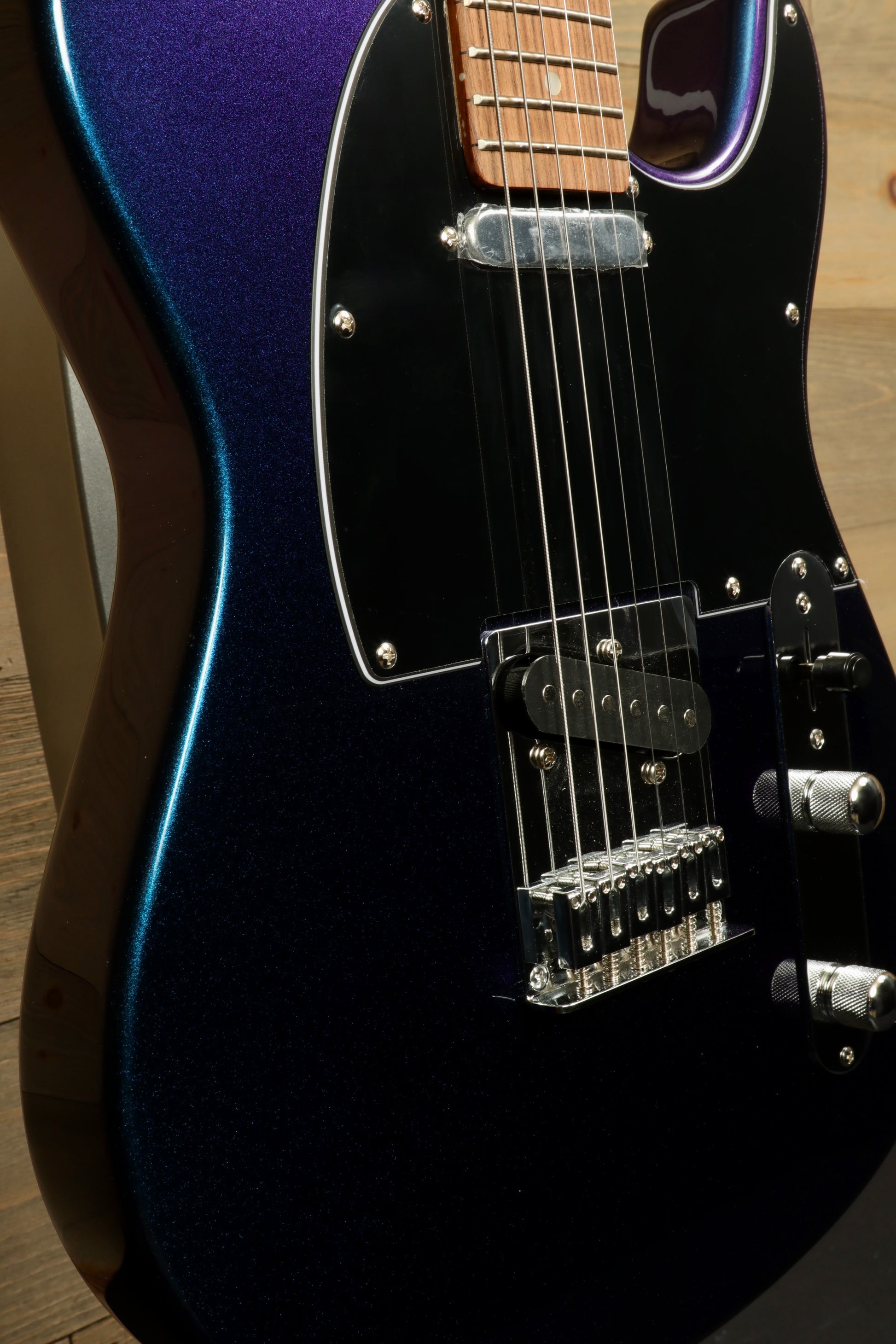 Tagima TW 55 MCBL/BK Electric Guitar with a sleek blue-purple finish, side view showcasing hardware and body shape
