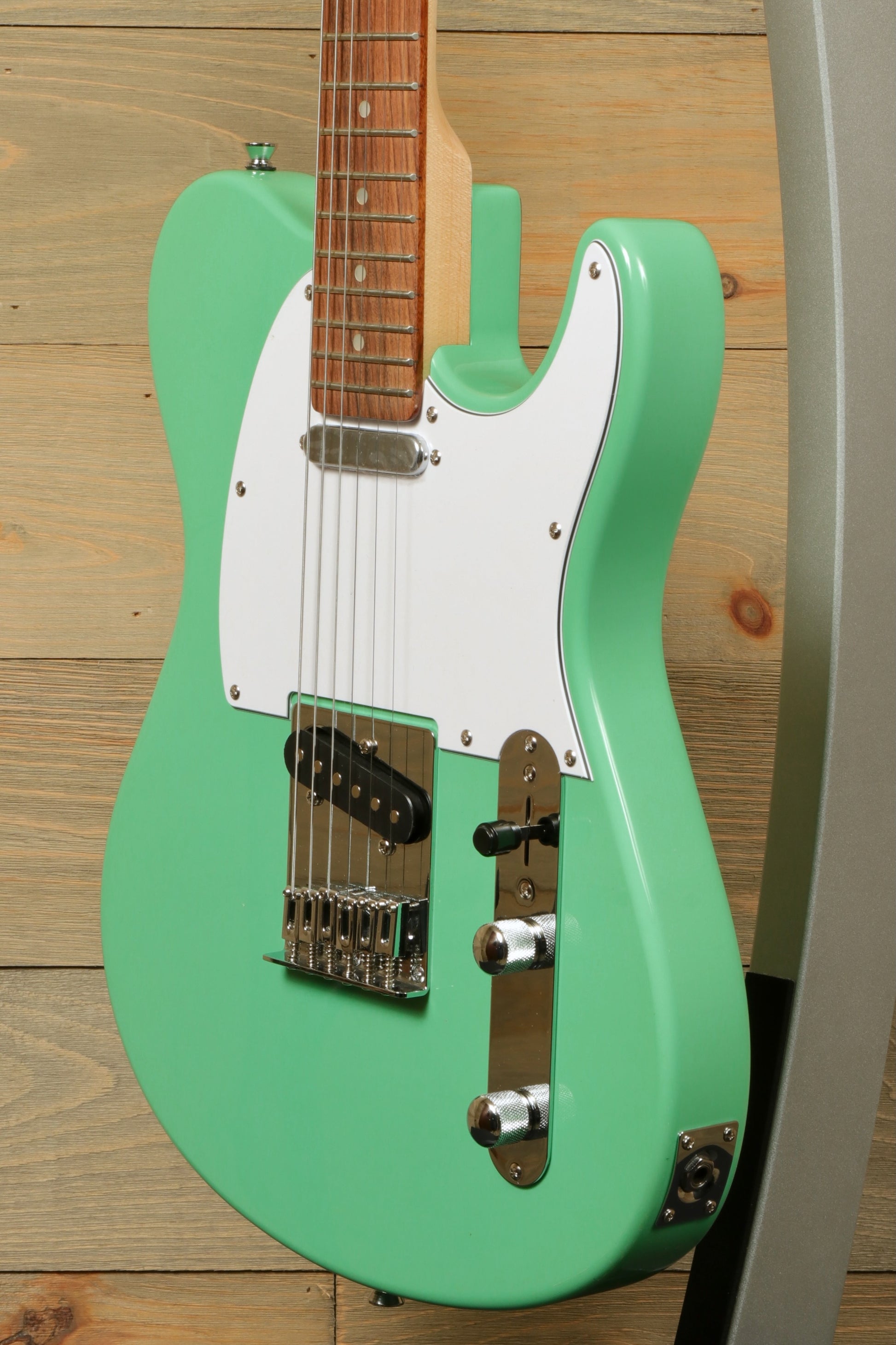 Tagima electric guitar guitars in mint green, side view with a white pickguard
