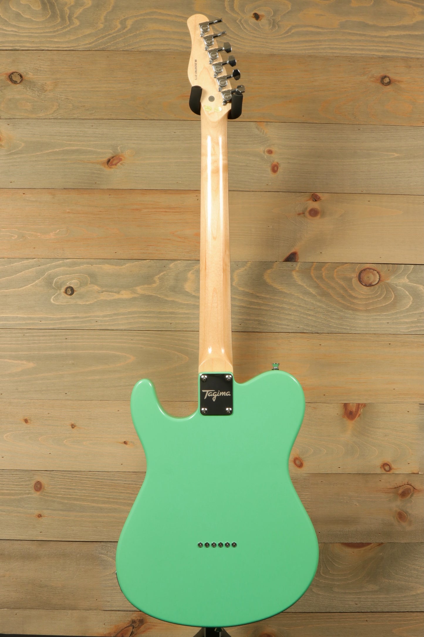Tagima electric guitar in mint green color, rear view showcasing sleek finish and neck