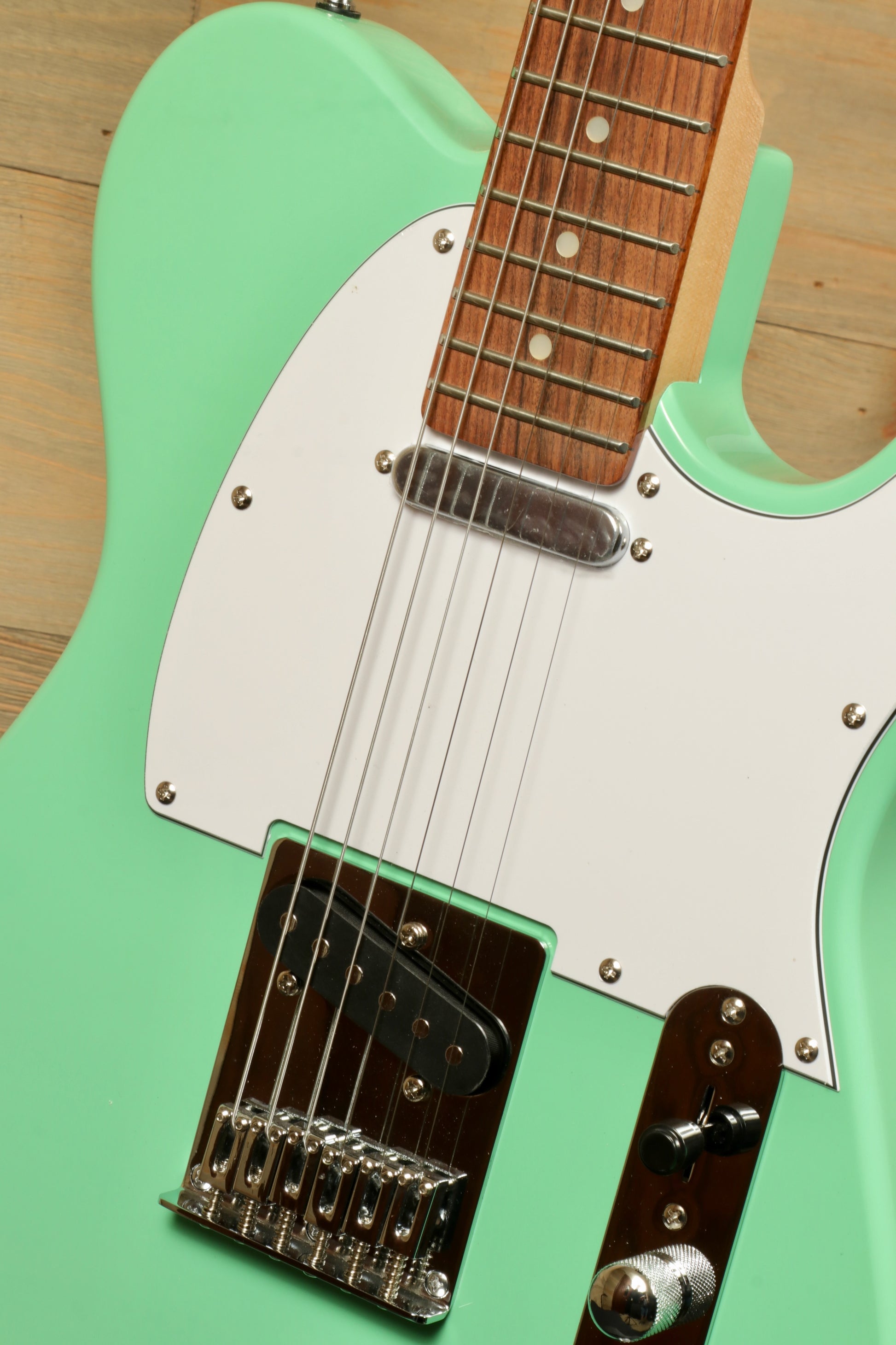 Tagima electric guitar in mint green finish, front view with wooden neck and chrome hardware
