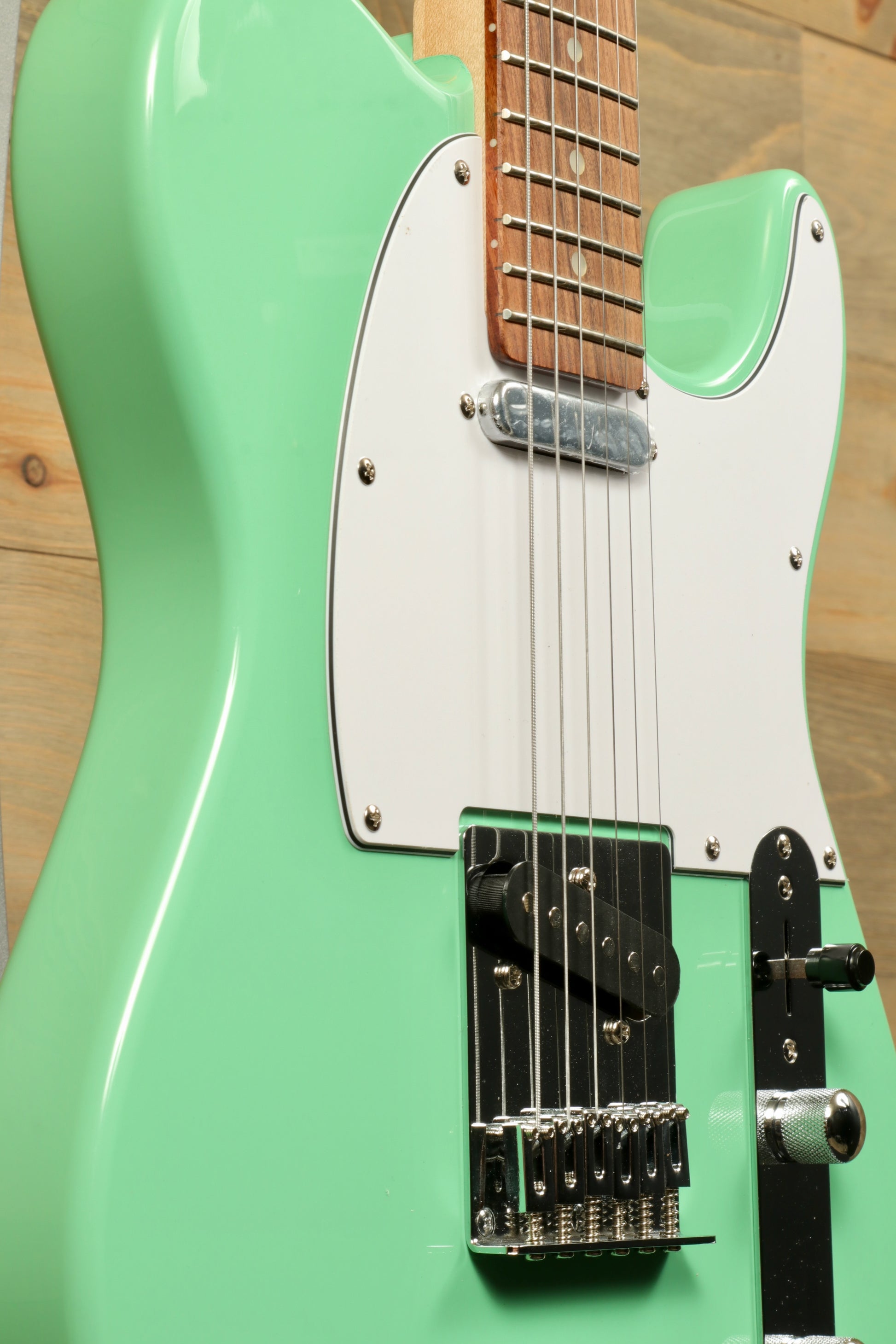 Tagima electric guitar guitars in mint green with a sleek body and chrome hardware, side view