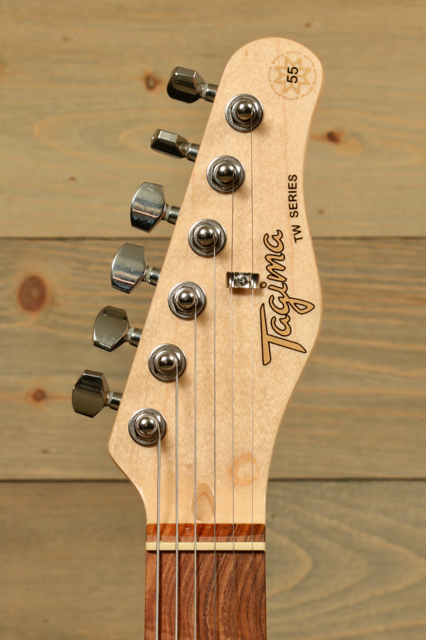 Tagima TW Series electric guitar headstock with chrome tuners, natural wood finish